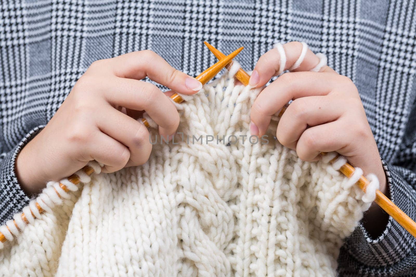 Close up of hands knitting warm sweater