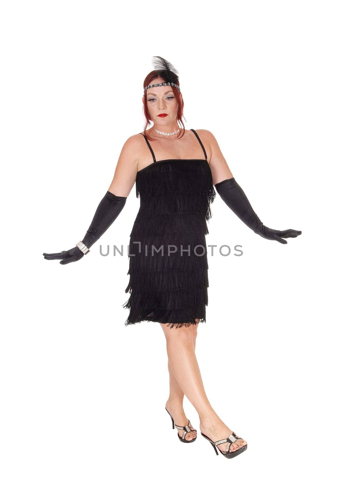 A gorgeous woman in a black dress of the 20 century and long cloves.dancing in the studio, isolated for white background.
