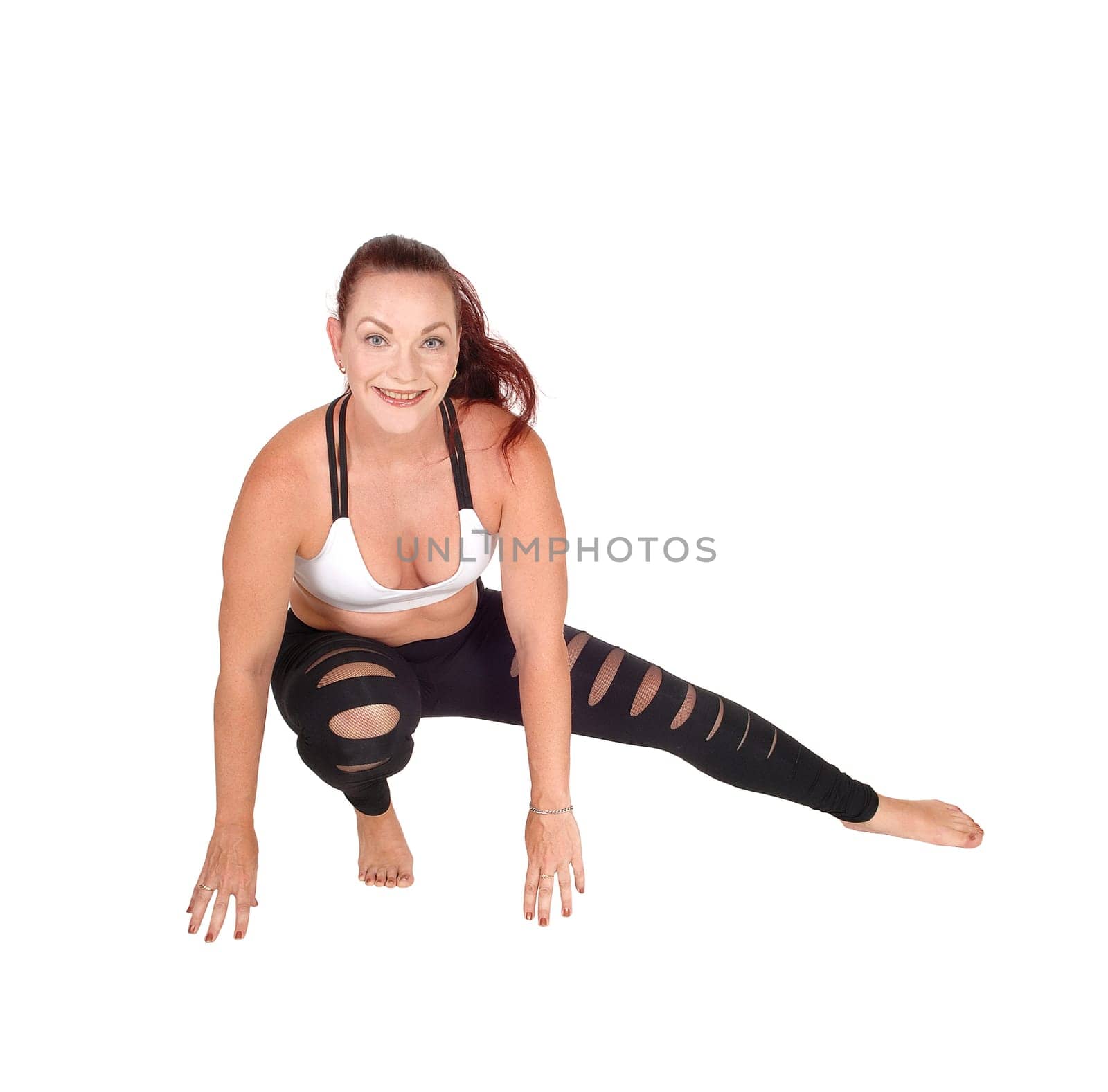 A woman in exercise outfit crouching on the floor doing her workout,.isolated for white background.