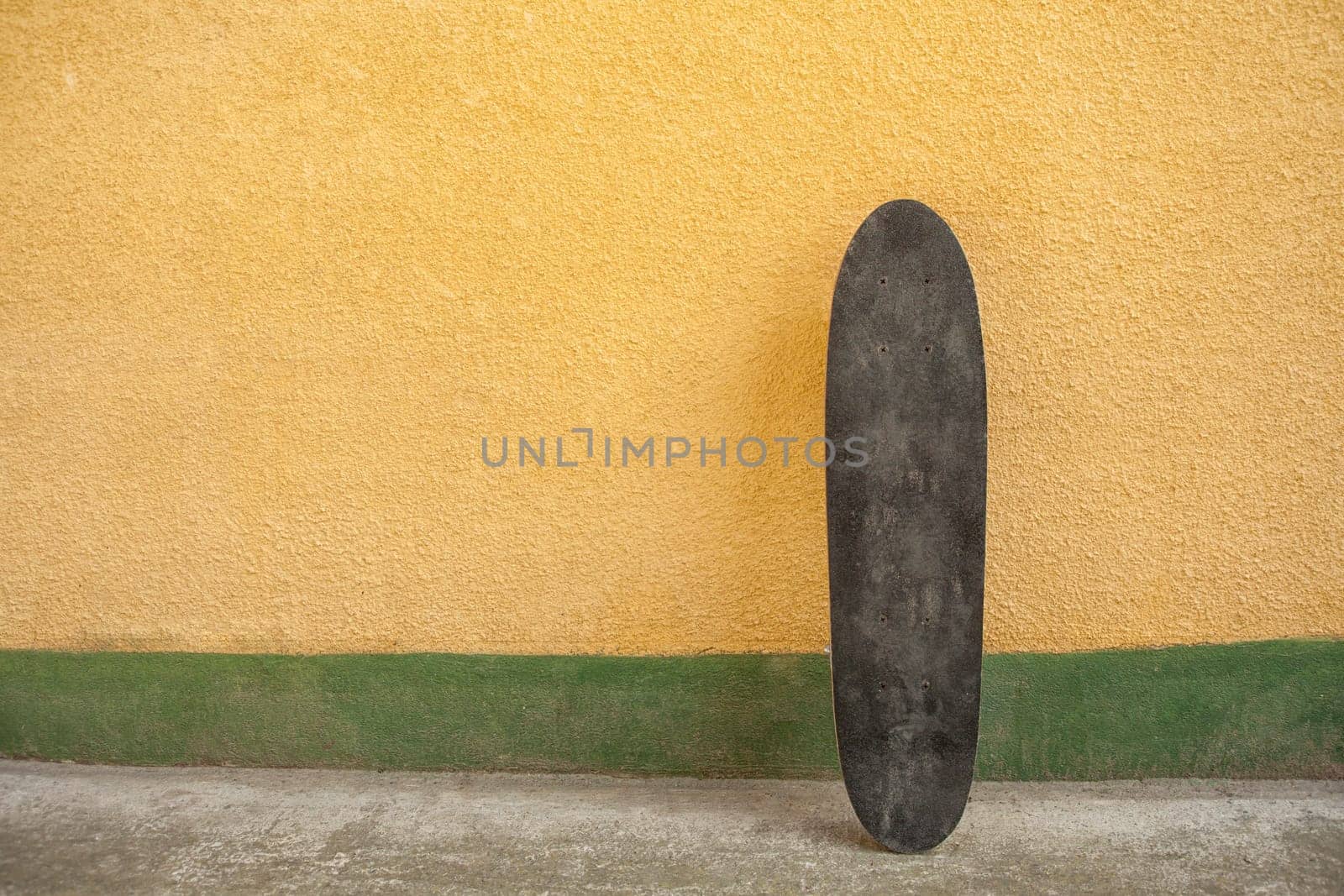 Skateboard on a wall. Used skateboard.