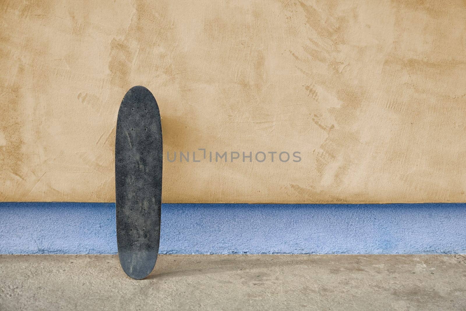 Skateboard on a wall. Used skateboard.