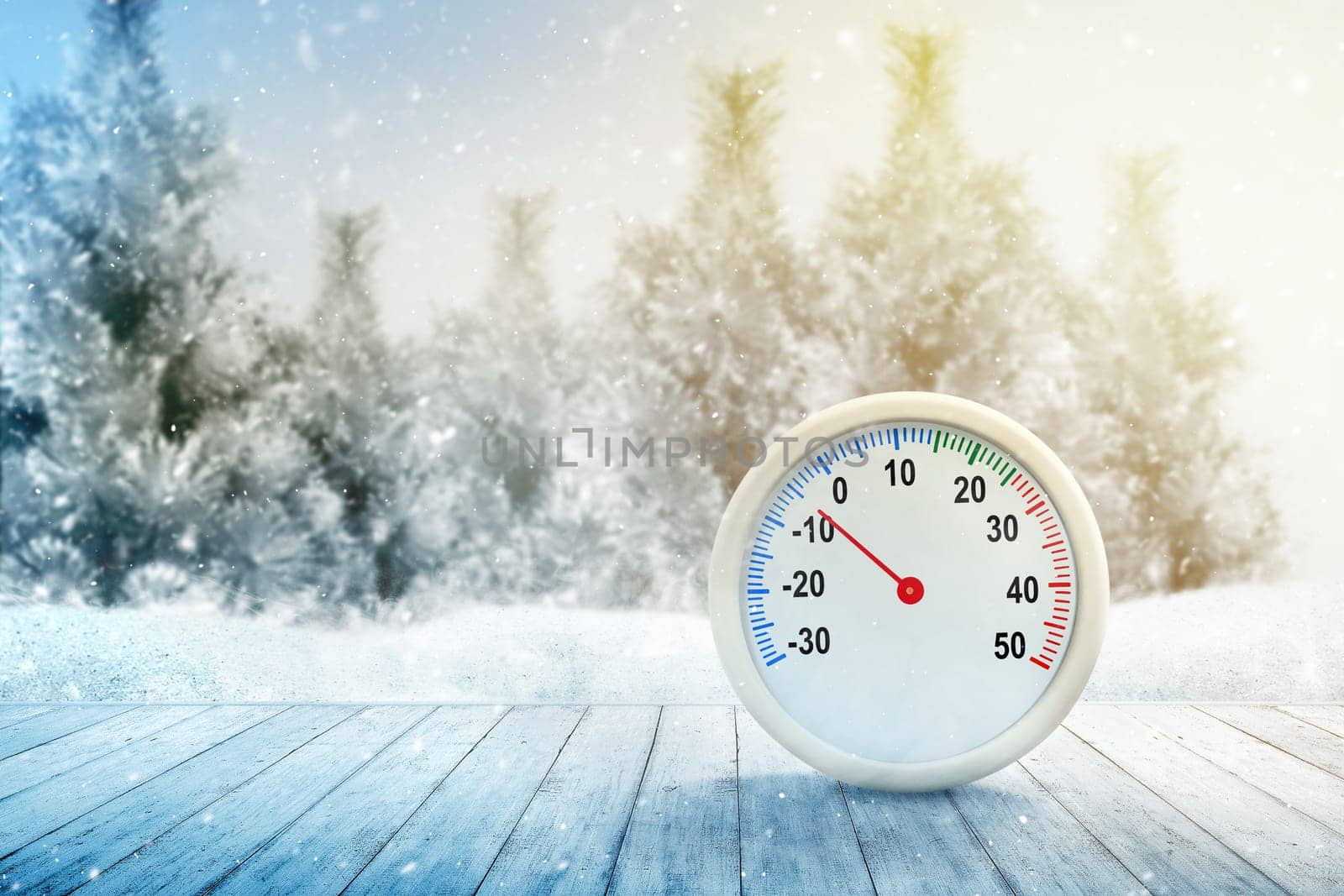The thermometer on a wooden table with the low temperature at winter with snowfall background