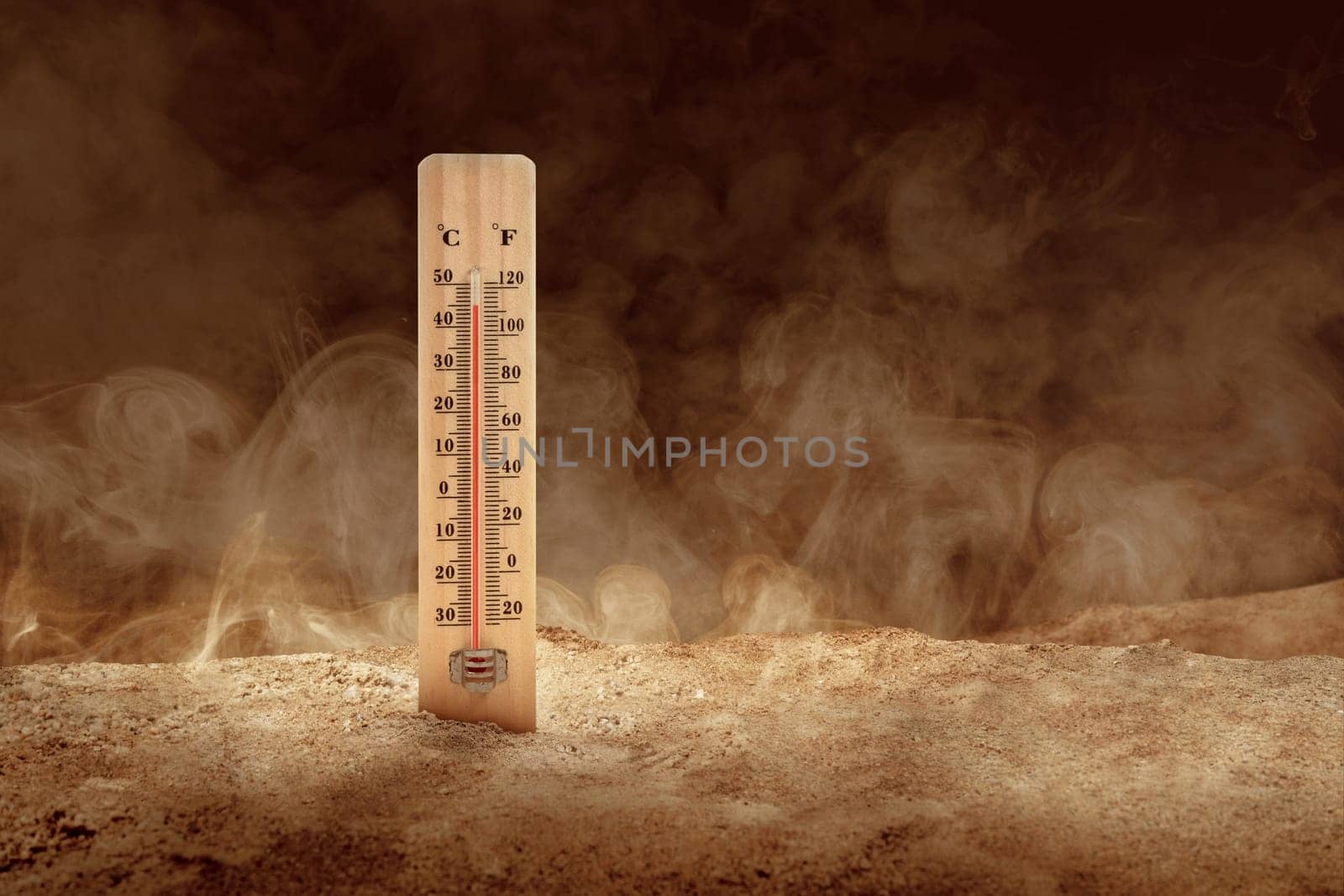 Thermometer with high temperature on the desert with a dusty background. Heatwave concept