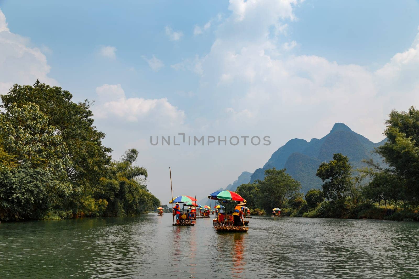 Bamboo rafts on Yulong (Dragon) River on rainy day. China. Yulong River Rafting is main tourist activity in Yangshuo area