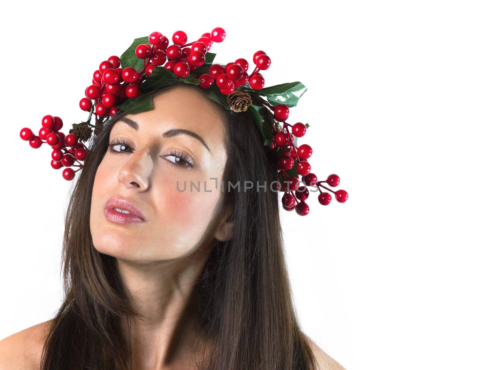 Smiling young woman with wearing a Christmas wreath on her head. Natural makeup. Christmas or New Year beauty woman portrait isolated on white background.