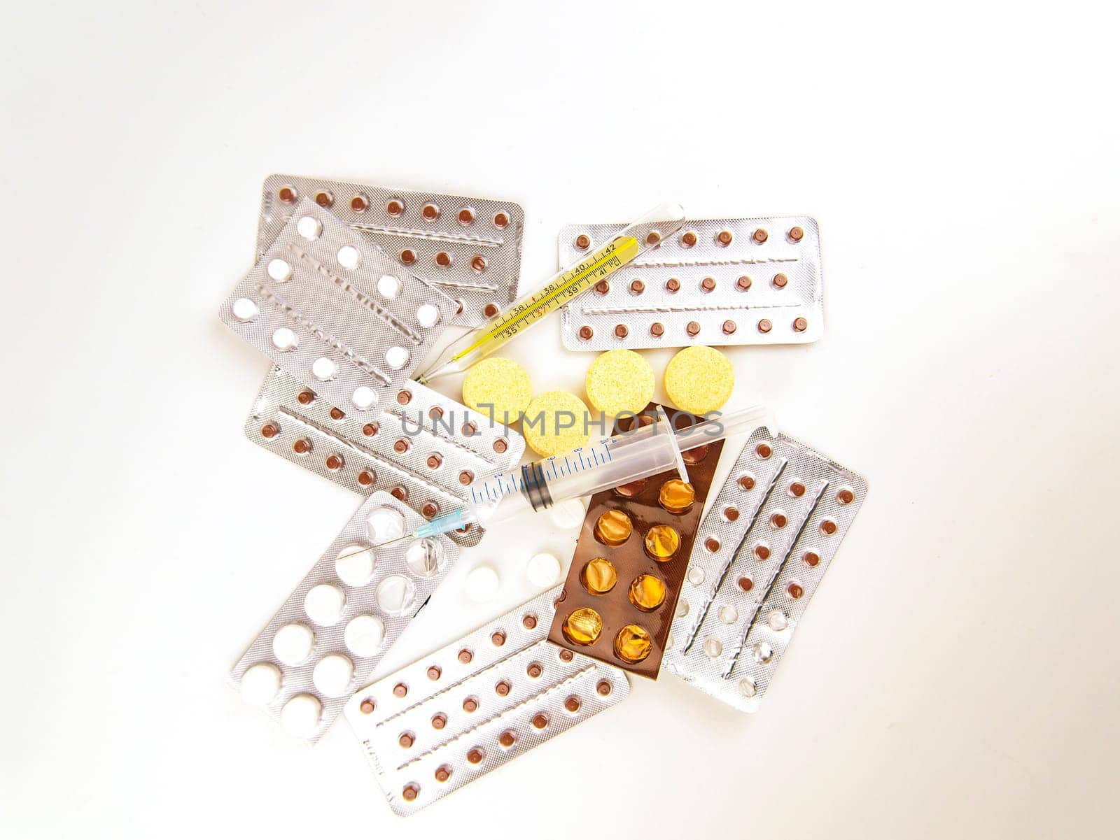 Medical syringe and thermometer on tablets. Place for text. Medicine and health. Injection