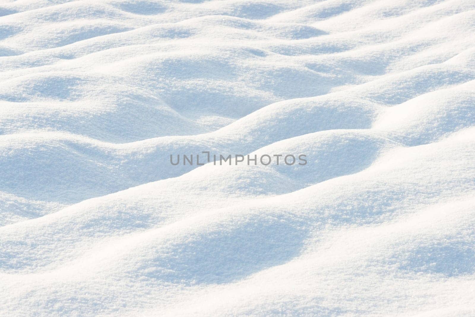 Cose up of a snow-covered field in the sunshine with copy space