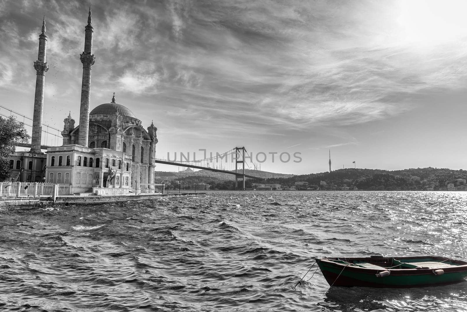 Ortakoy Mosque, the Bosphorus bridge and a boat by the pier, black and white image, Istanbul.
