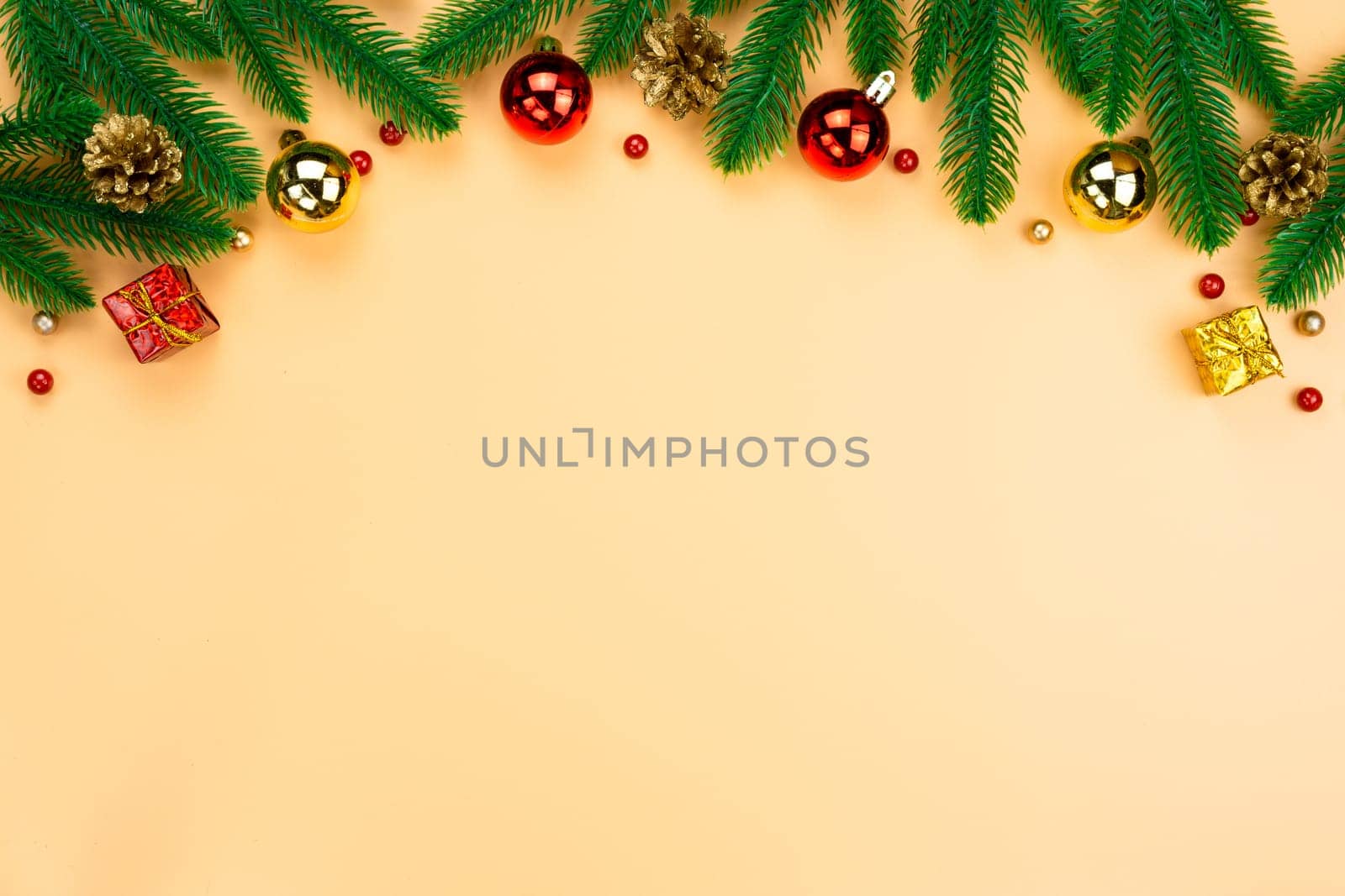 Christmas holidays composition, top view of red and gold Christmas decorations on yellow background with copy space for text. Flat lay, winter, postcard template, new year concept.