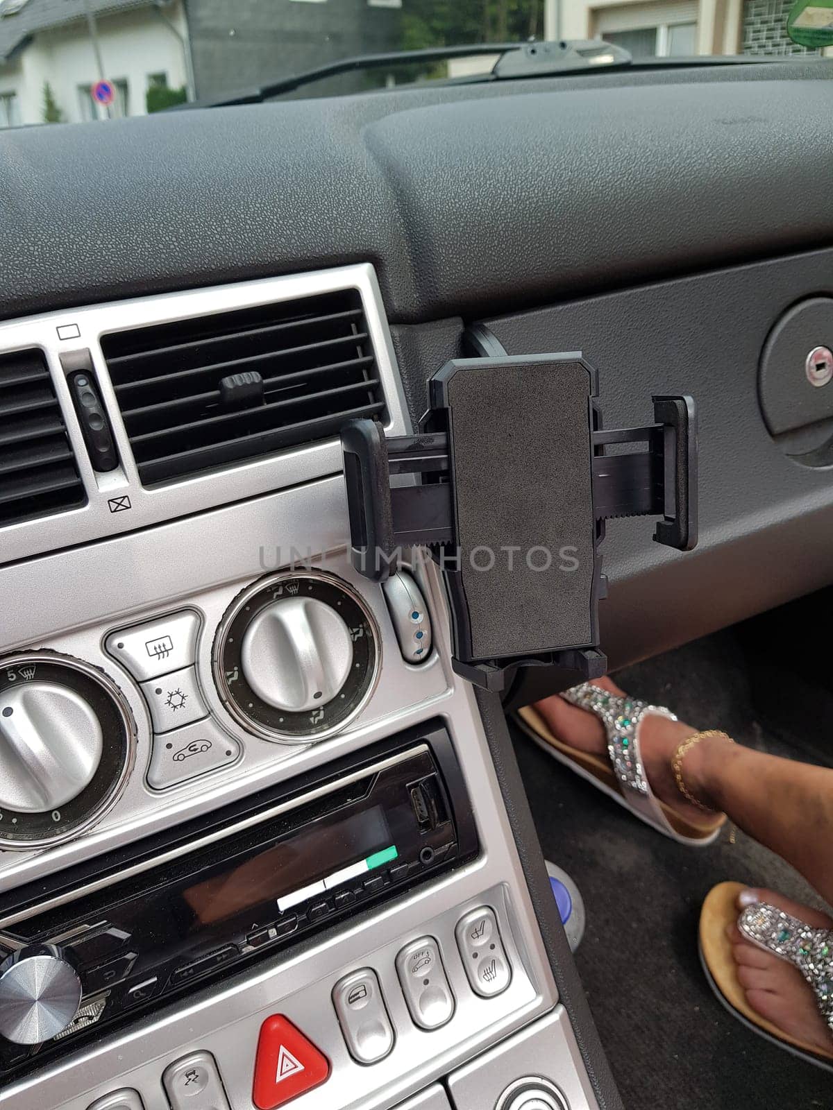 Close up, car interior of a sports car. Passenger seats in modern luxury sports car with mobile phone holder and bluetooth.