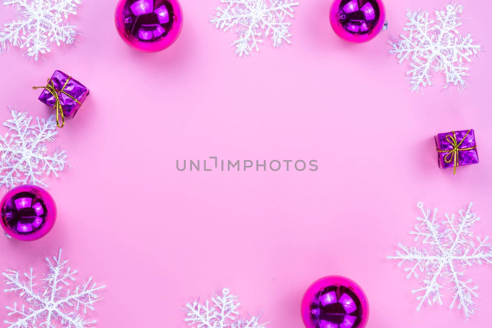 Christmas holidays composition, top view of pink Christmas decorations on pink background with copy space for text. Flat lay, winter, postcard template, new year concept.