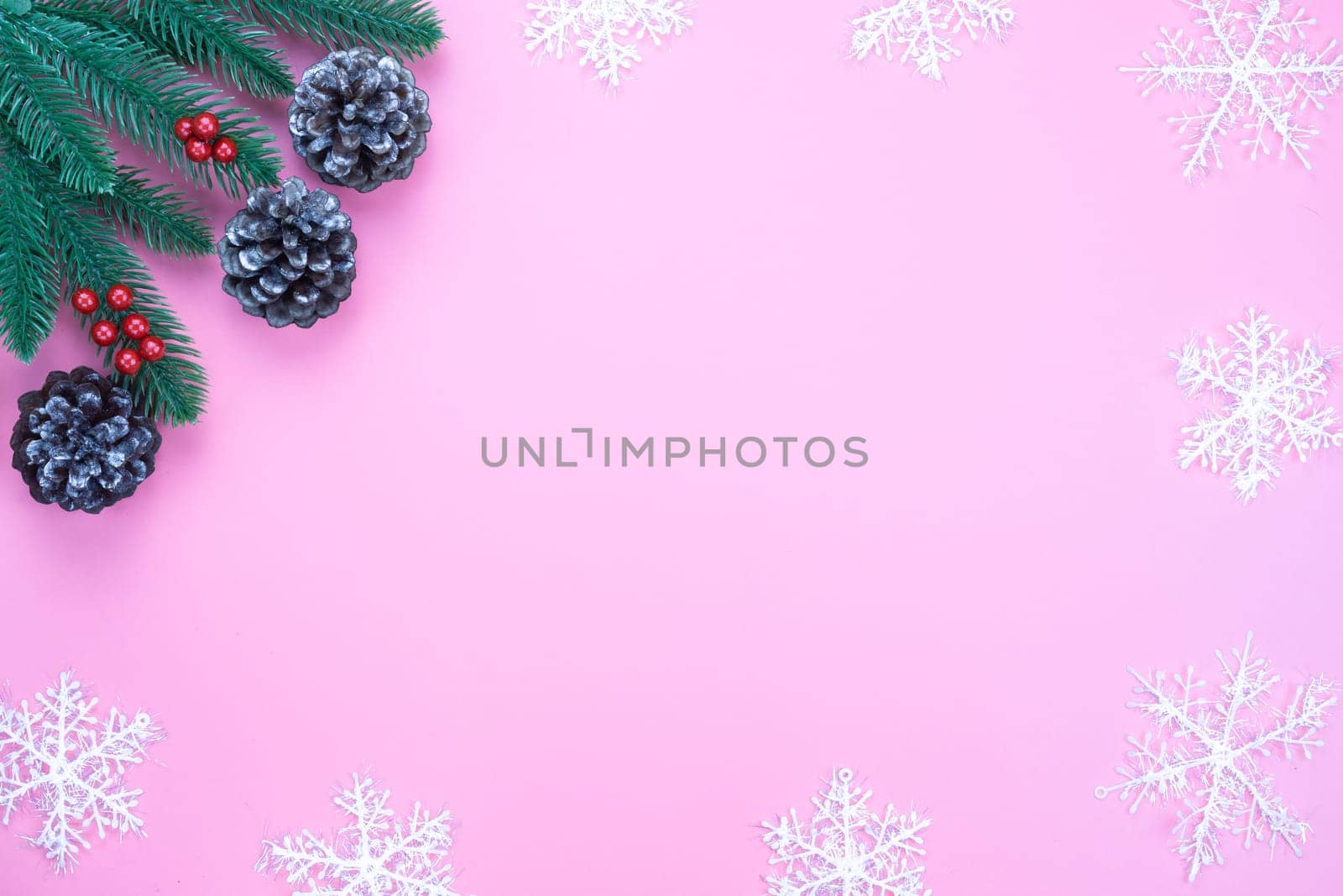 Christmas holidays composition, top view of red Christmas decorations on pink background with copy space for text. Flat lay, winter, postcard template, new year concept.