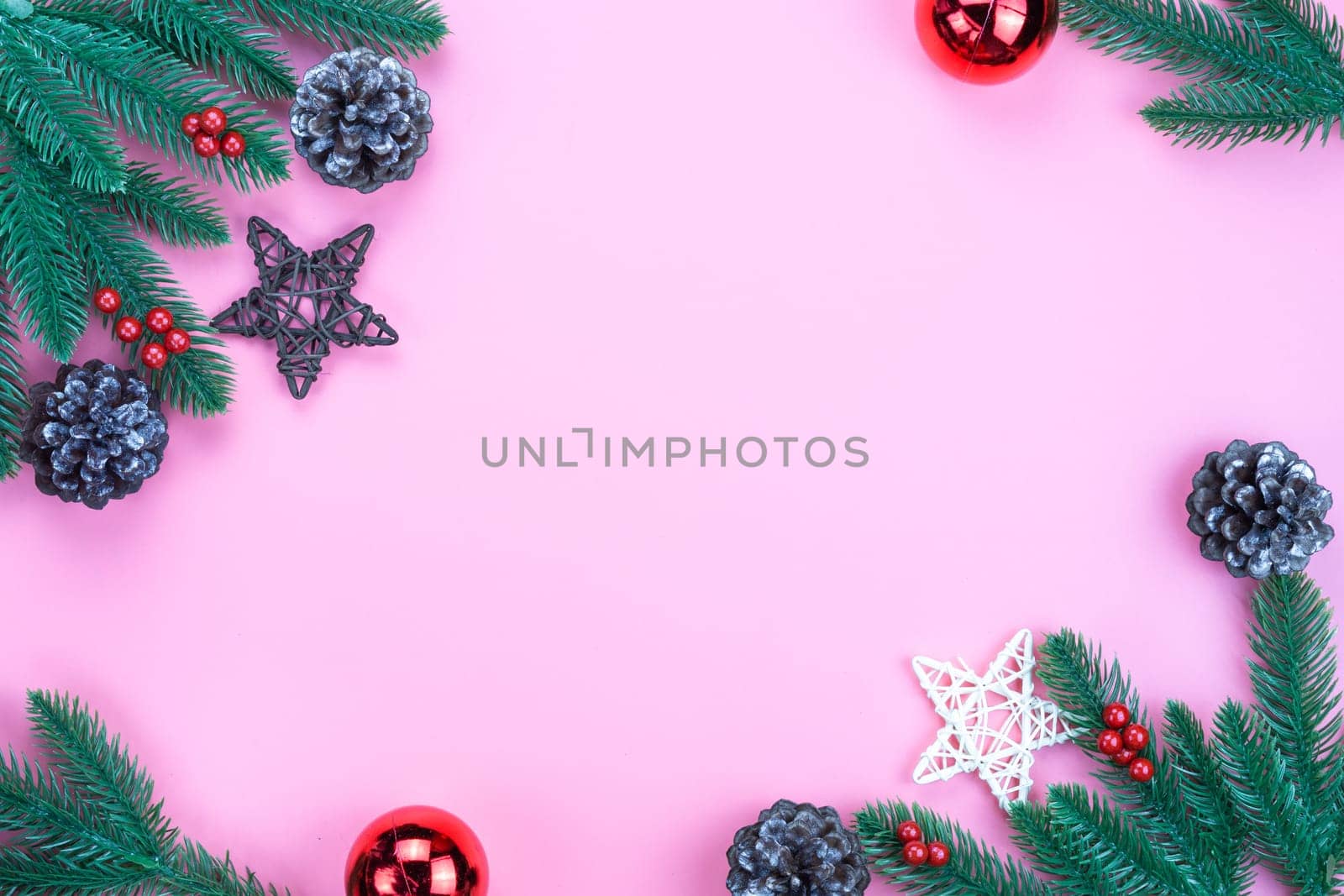 Christmas holidays composition, top view of red Christmas decorations on pink background with copy space for text. Flat lay, winter, postcard template, new year concept.