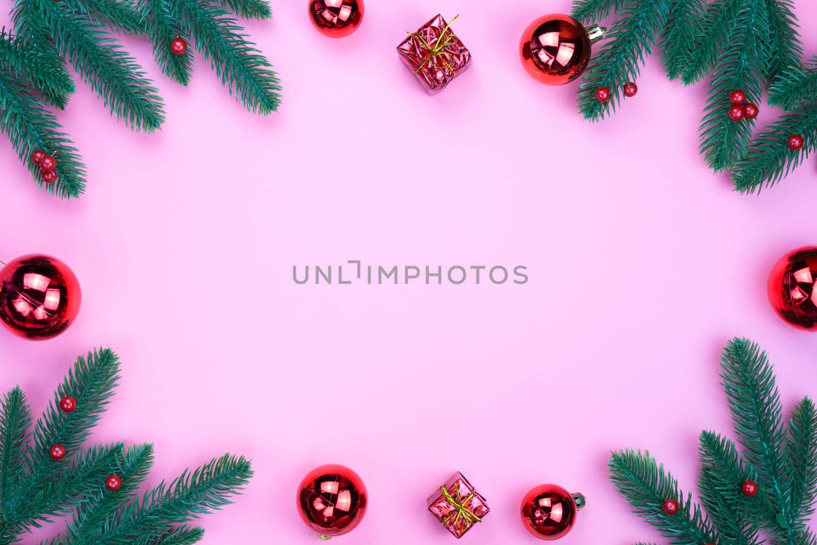 Christmas holidays composition, top view of red Christmas decorations on pink background with copy space for text. Flat lay, winter, postcard template, new year concept.