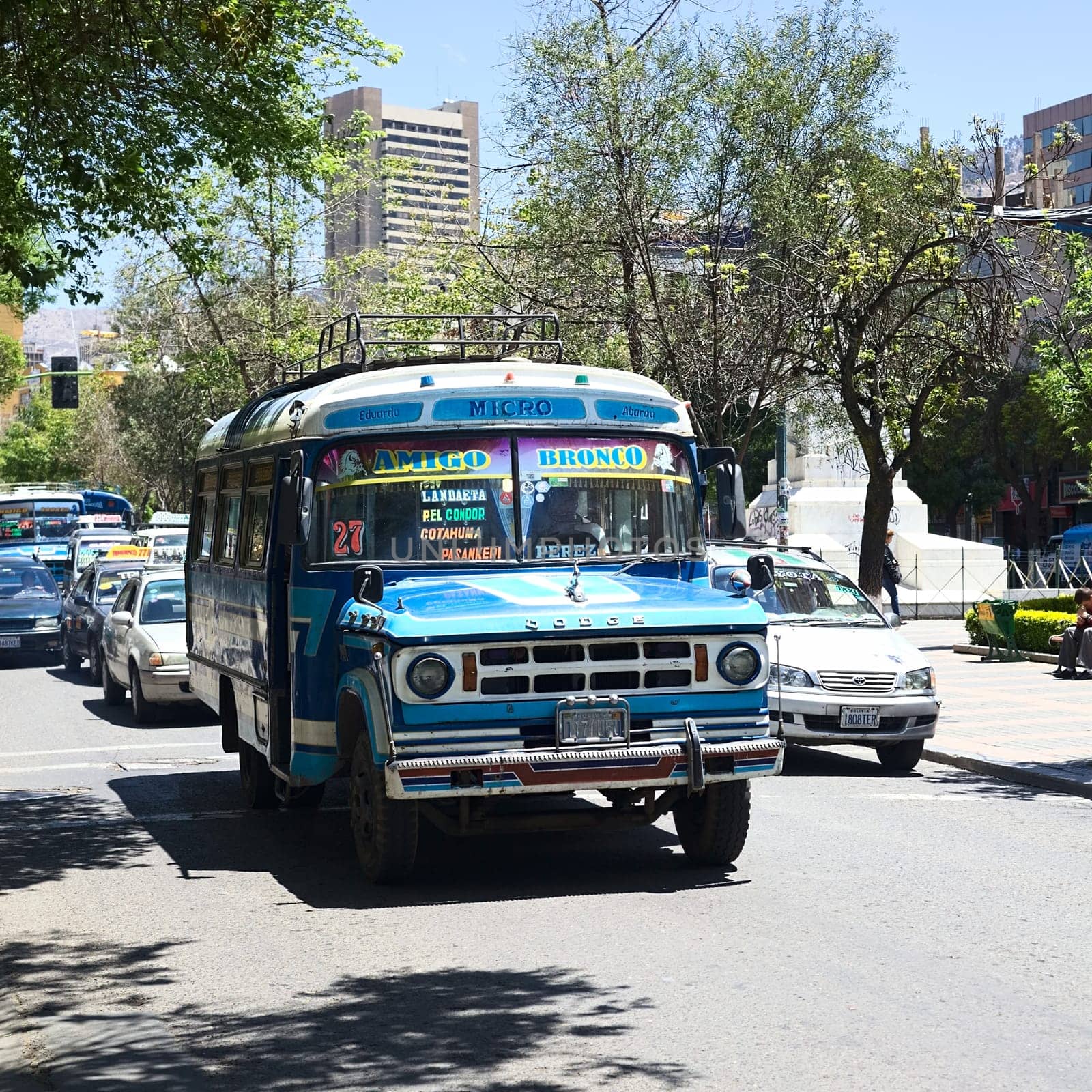 LA PAZ, BOLIVIA - OCTOBER 15, 2014: An old blue Dodge D400 bus used for public transportation driving on El Prado avenue in the city center on October 15, 2014 in La Paz, Bolivia