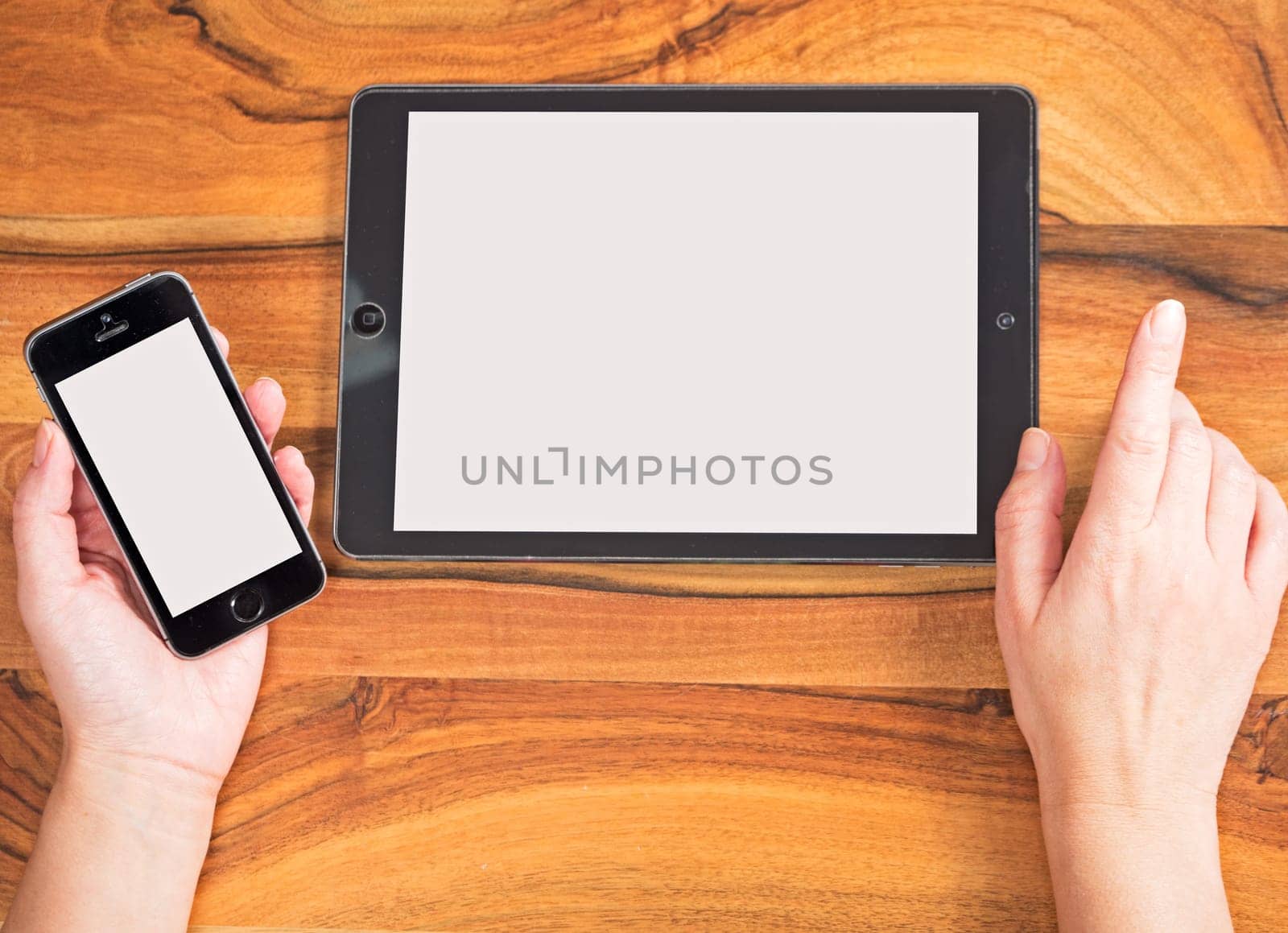 Hands with smartphone and tablet