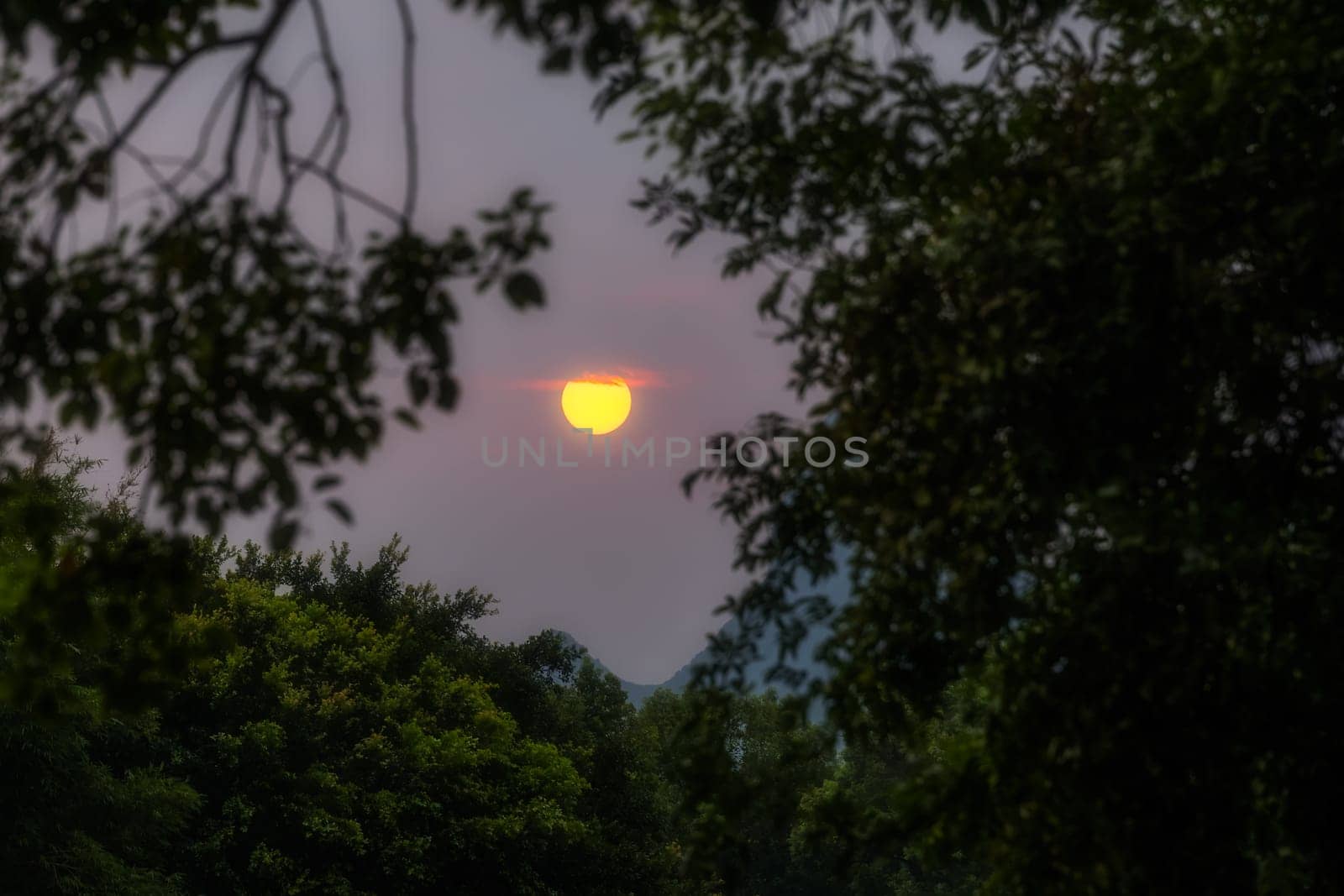 Sun setting over the karst mountains landscape and  Shan Lake, Guilin town, Guangxi Province, China