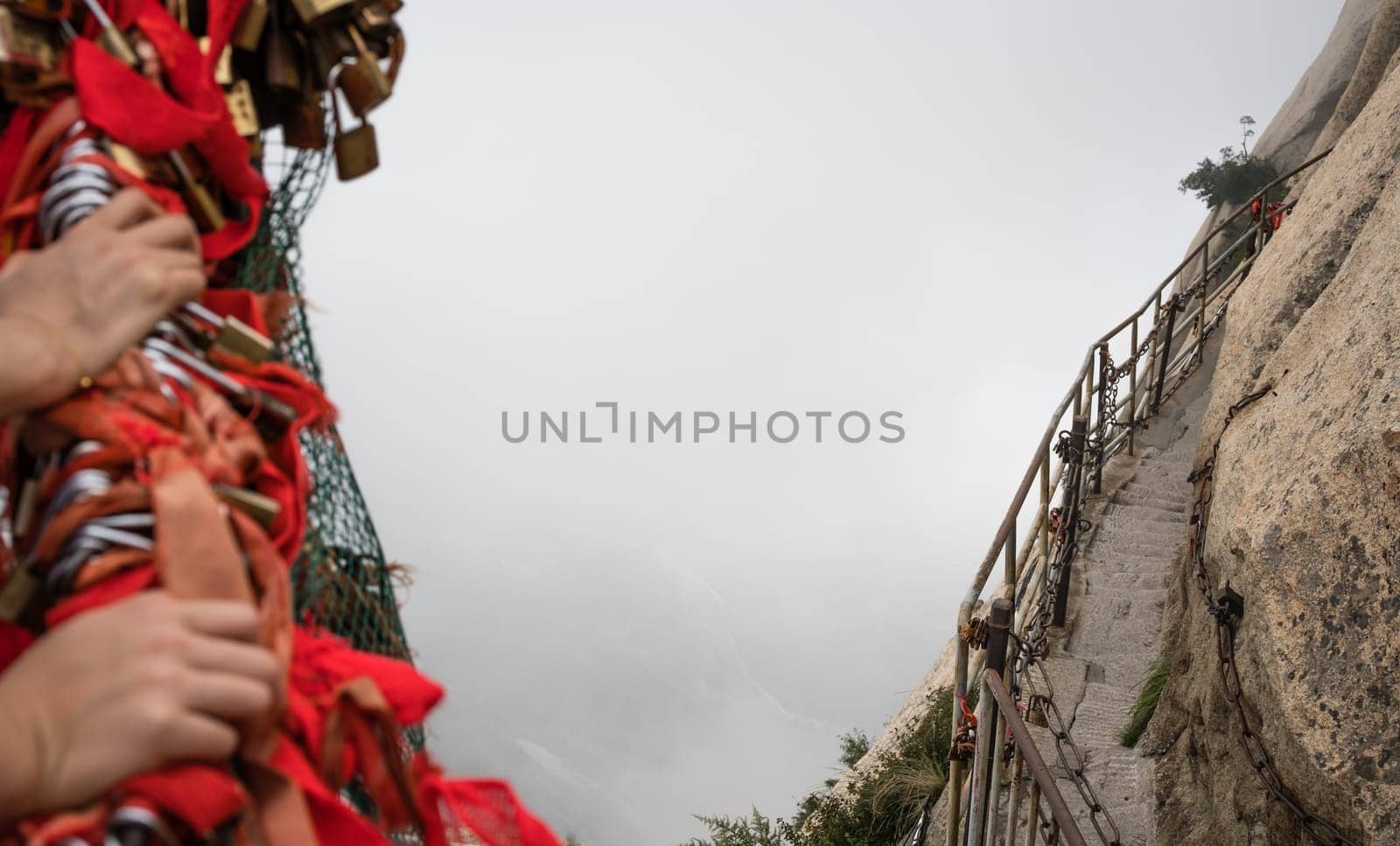 Stone steps cut on a side of a mountain rock leading to the dangerous and perilous Plank Walk trail, closed for public access due to bad weather conditions, Huashan mountain, Xian, Shaanxi Province, China