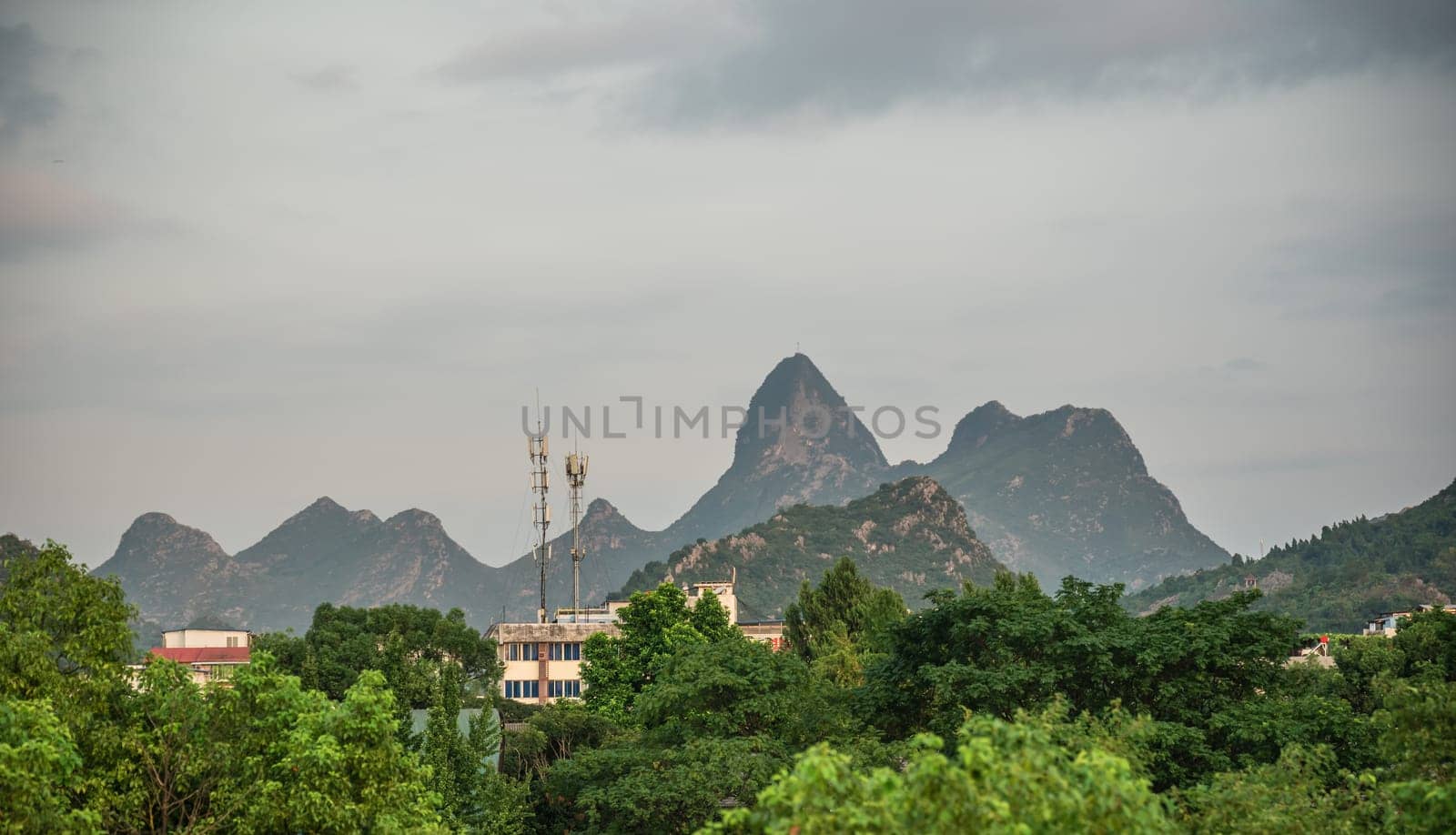 Buildings of Guilin town city with karst mountains in the background, Guangxi Province, China