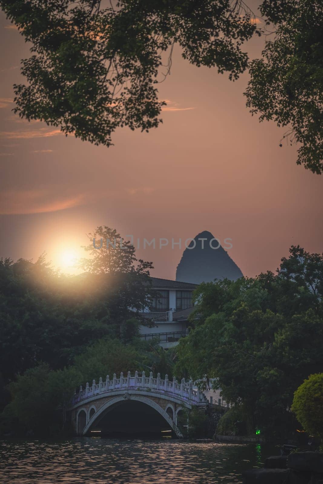 Beautiful sunset over the marble bridge on Shan Lake, Guilin town, Guangxi Province, China