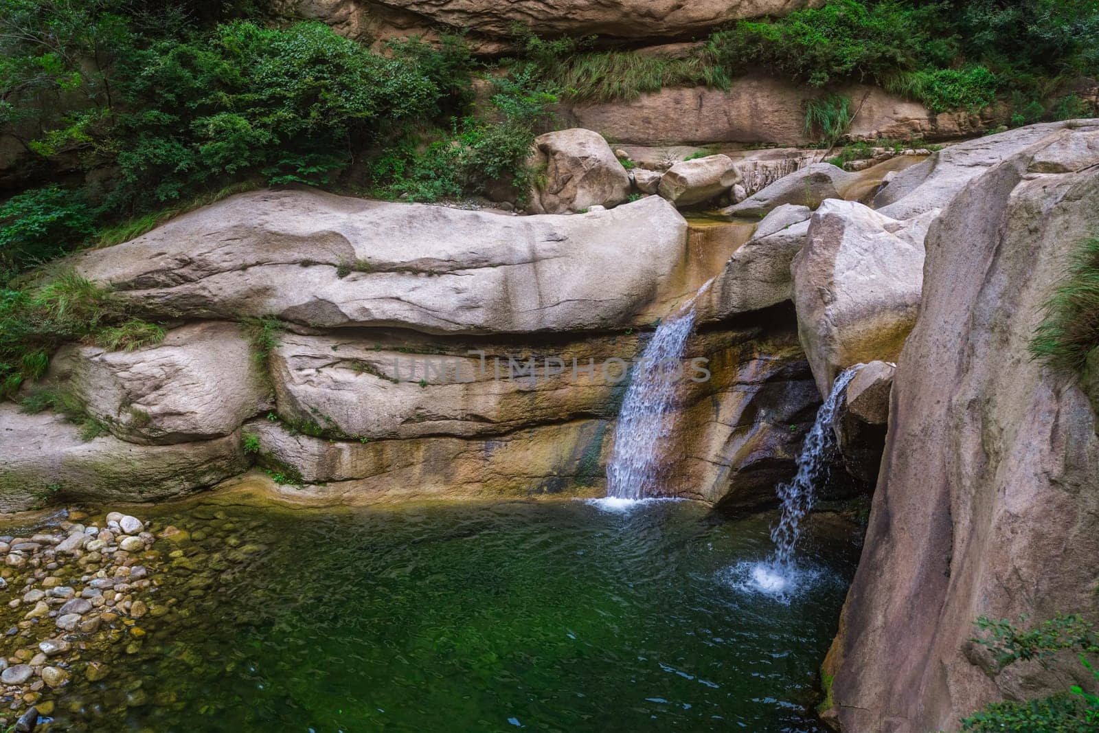 Small pond and waterfall under the Hua shan mountain, famous tourist attraction, Shaanxi province, China