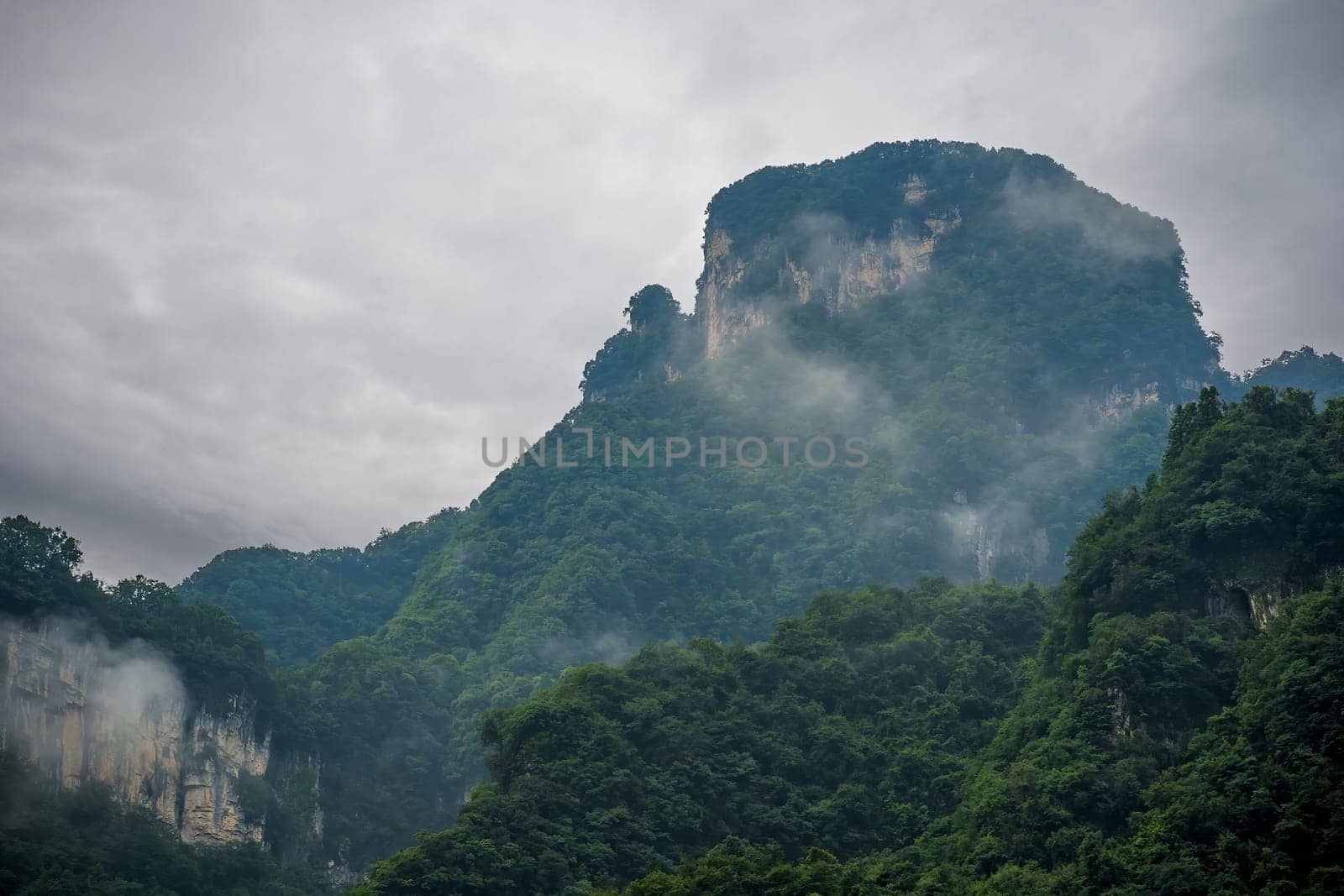 View  of the famous holy sacred Tianmen mountains covered in early morning fog and mist, Zhangjiajie, China