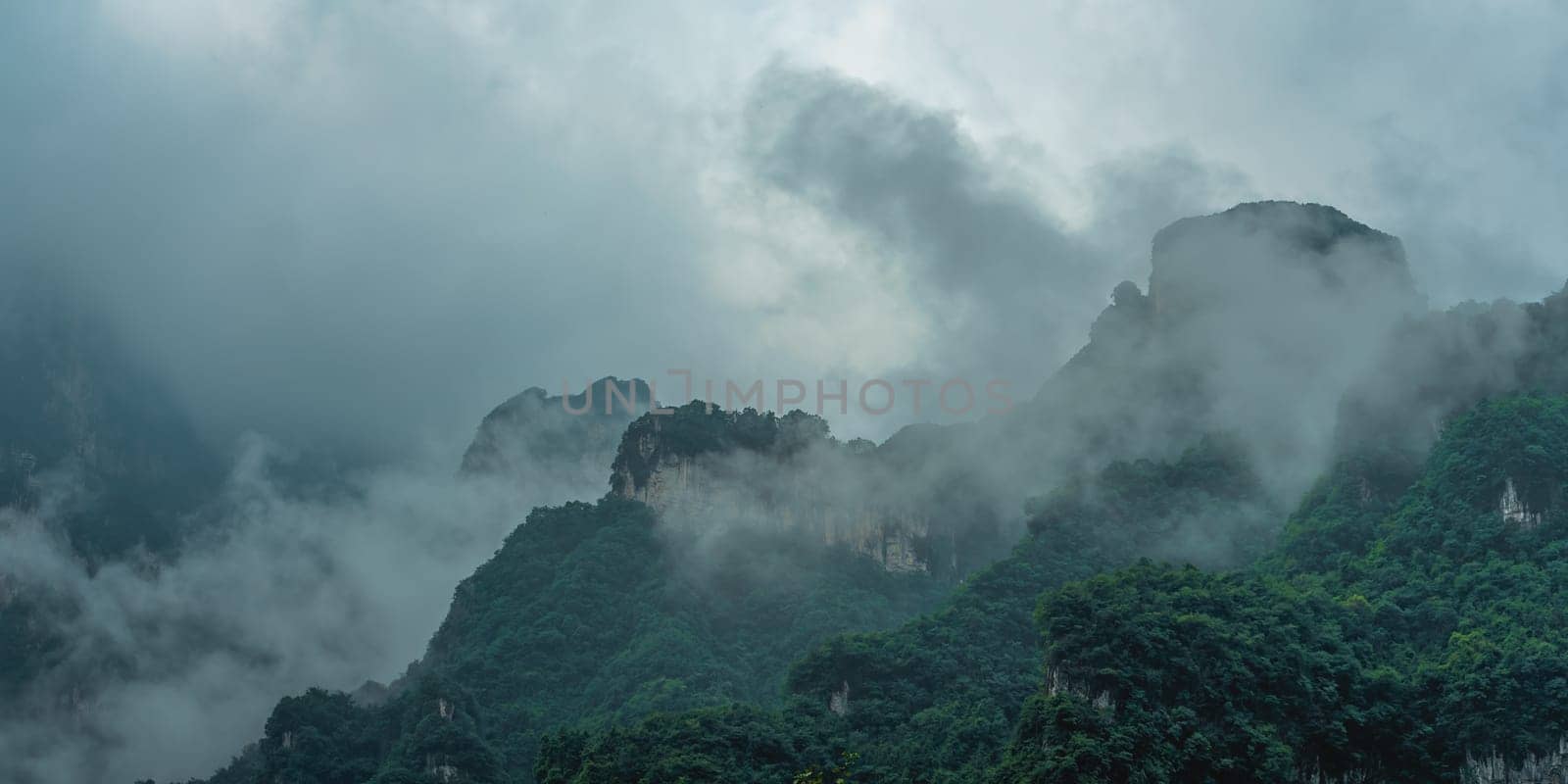View  of the famous holy sacred Tianmen mountains covered in early morning fog and mist, Zhangjiajie, China