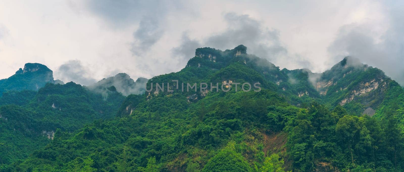 Panoramic view of the famous holy sacred Tianmen mountains covered in early morning fog and mist, Zhangjiajie, China