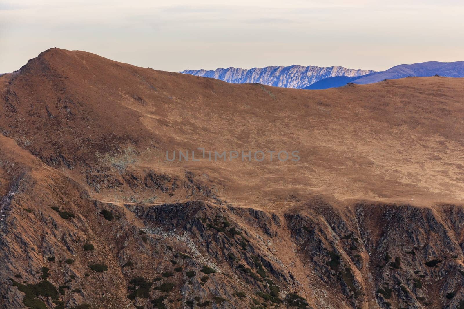 mountain landscape in Fagaras Mountains, Romania. In background Piatra Craiului Mountains