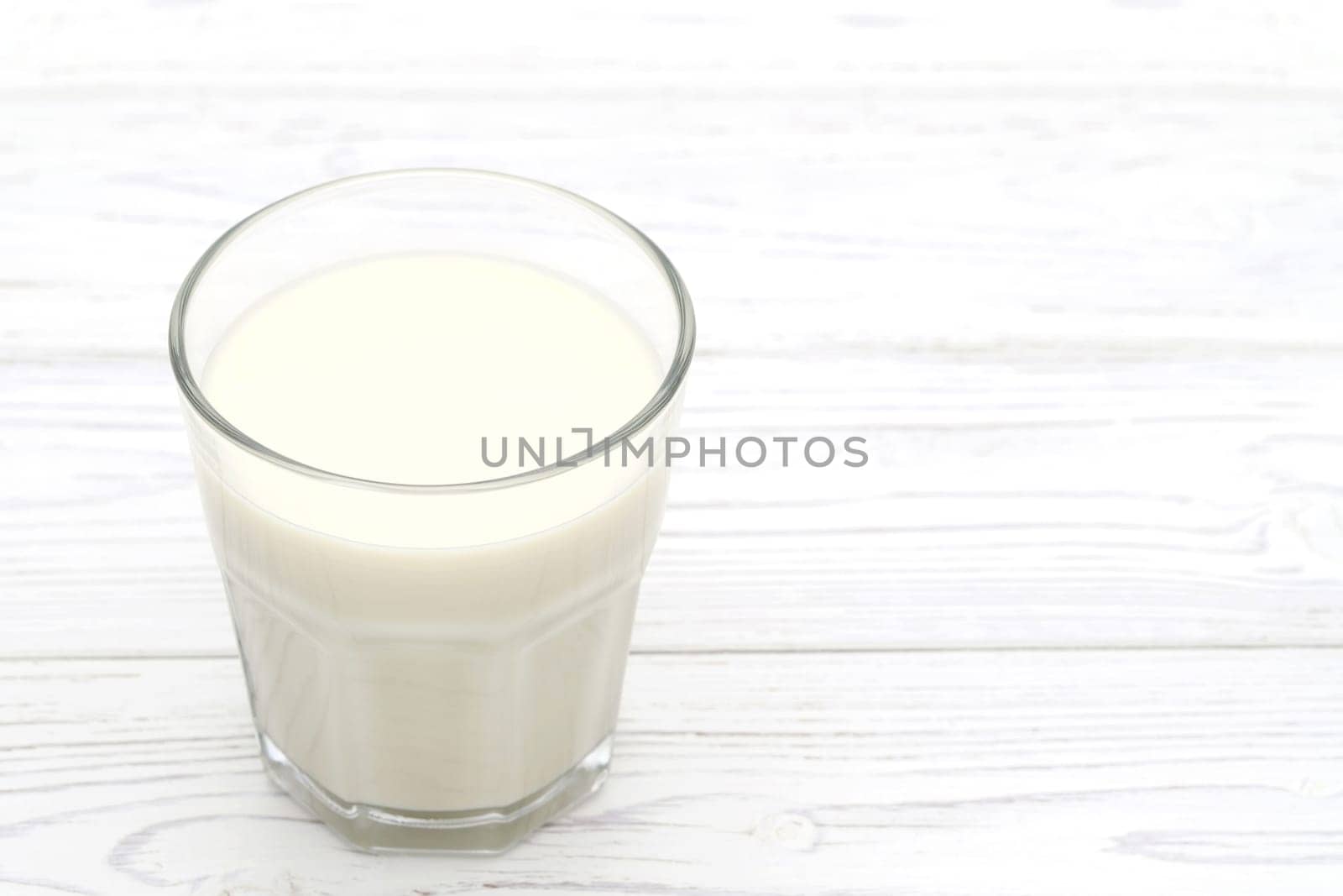 Glass of tonyu milk on wooden white table
