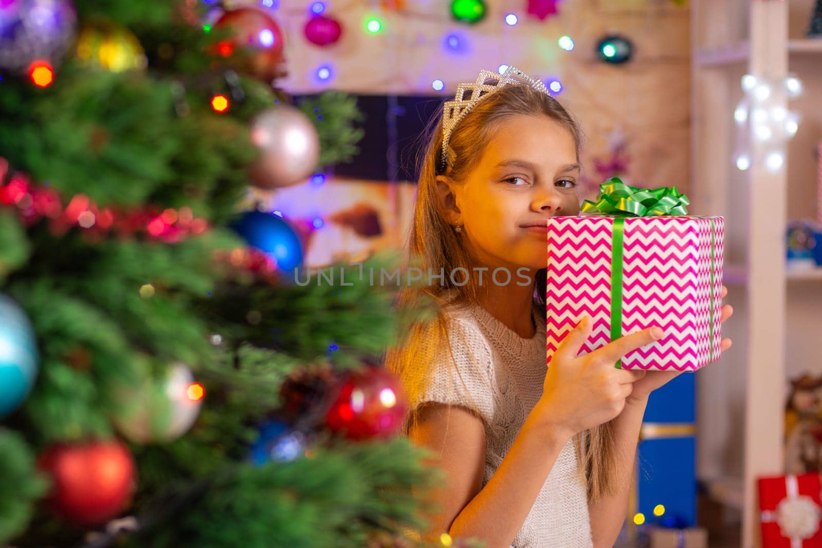 Beautiful girl hugged a treasured New Year's gift