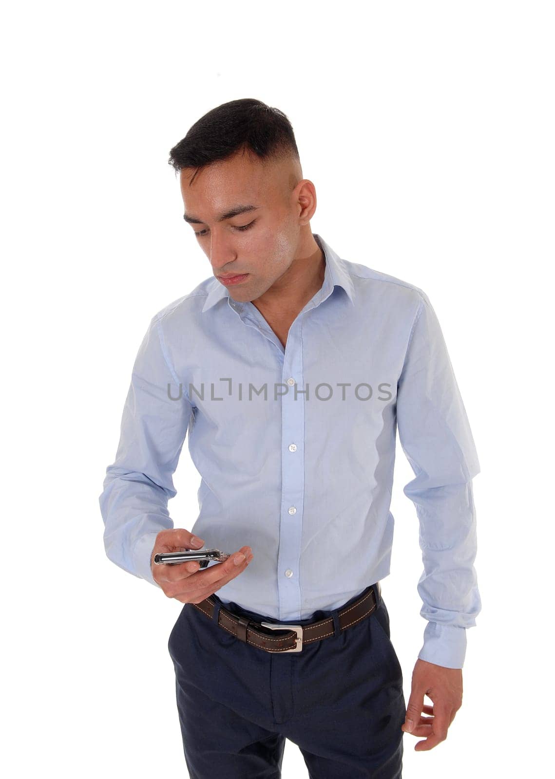 A young man is looking at his smart phone and is very disappointed .about the message he got, isolated for white background.