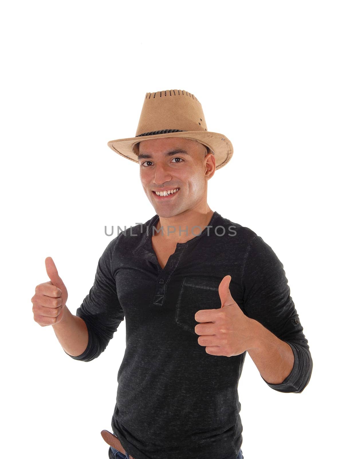 A young east Indian man standing in a black shirt and cowboy hat .making an OK sign, that he likes the idea, isolated for white background.
