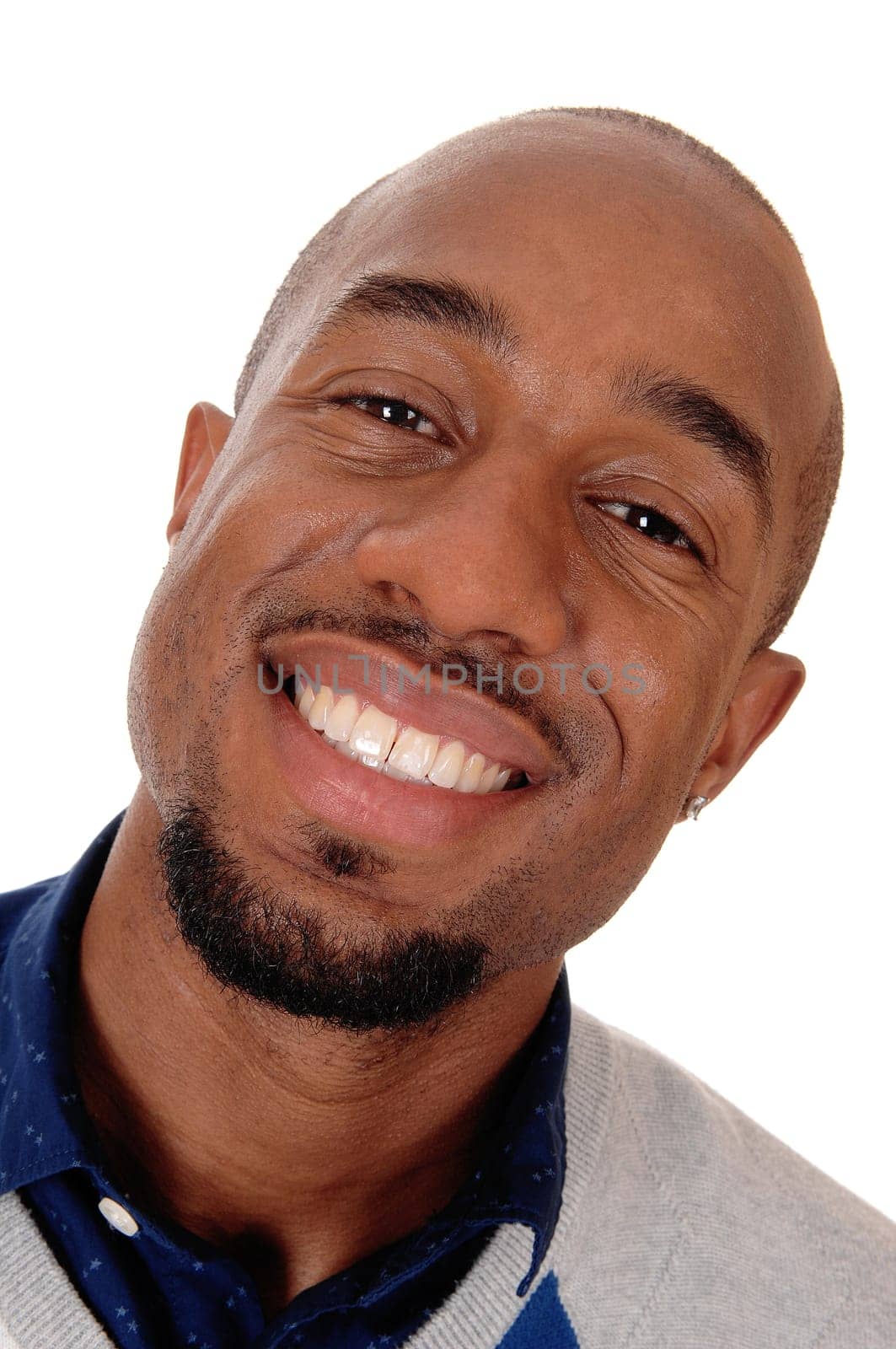 An close up portrait image of an African American man smiling bald.and with a small beard, isolated for white background.