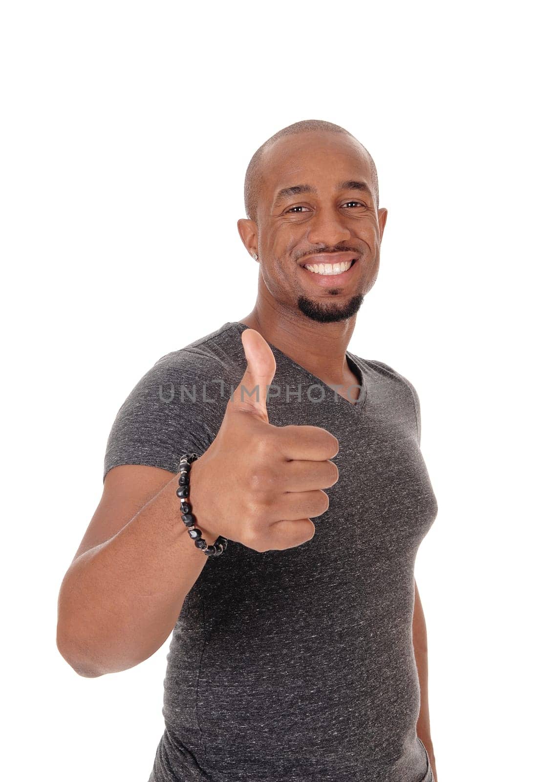 A smiling African American man standing in a sweater pointing with his.thump to the other person, isolated for white background.