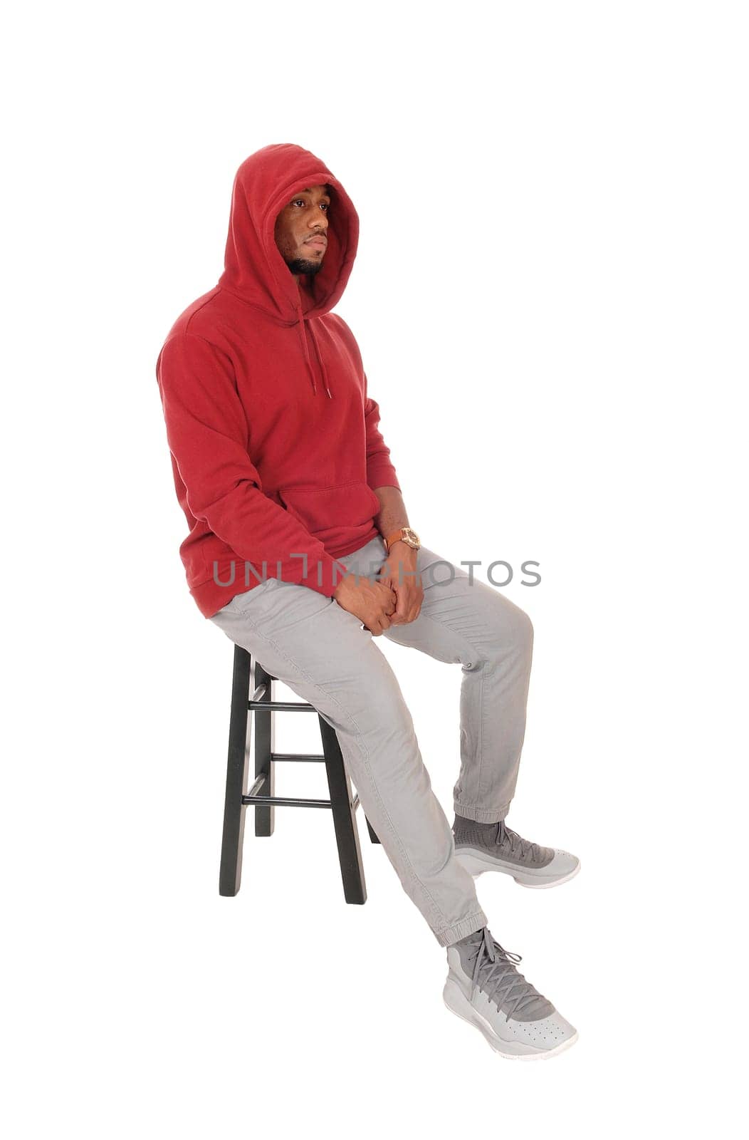 A close up image of an African American young man wearing a burgundy.hoody with a beard, isolated for white background.