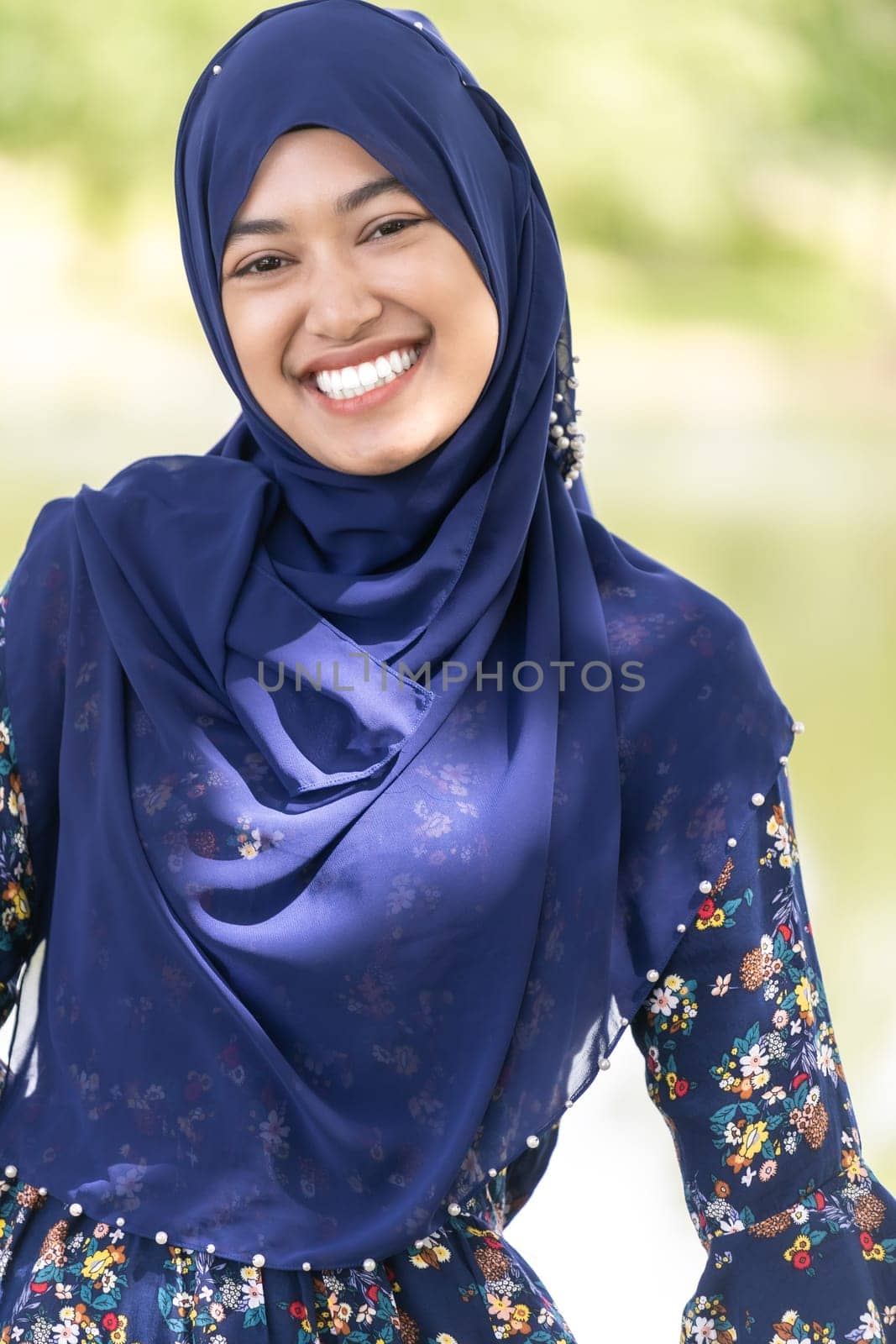 Portrait of good-looking Happy young teenager Muslim islamic asian university girl