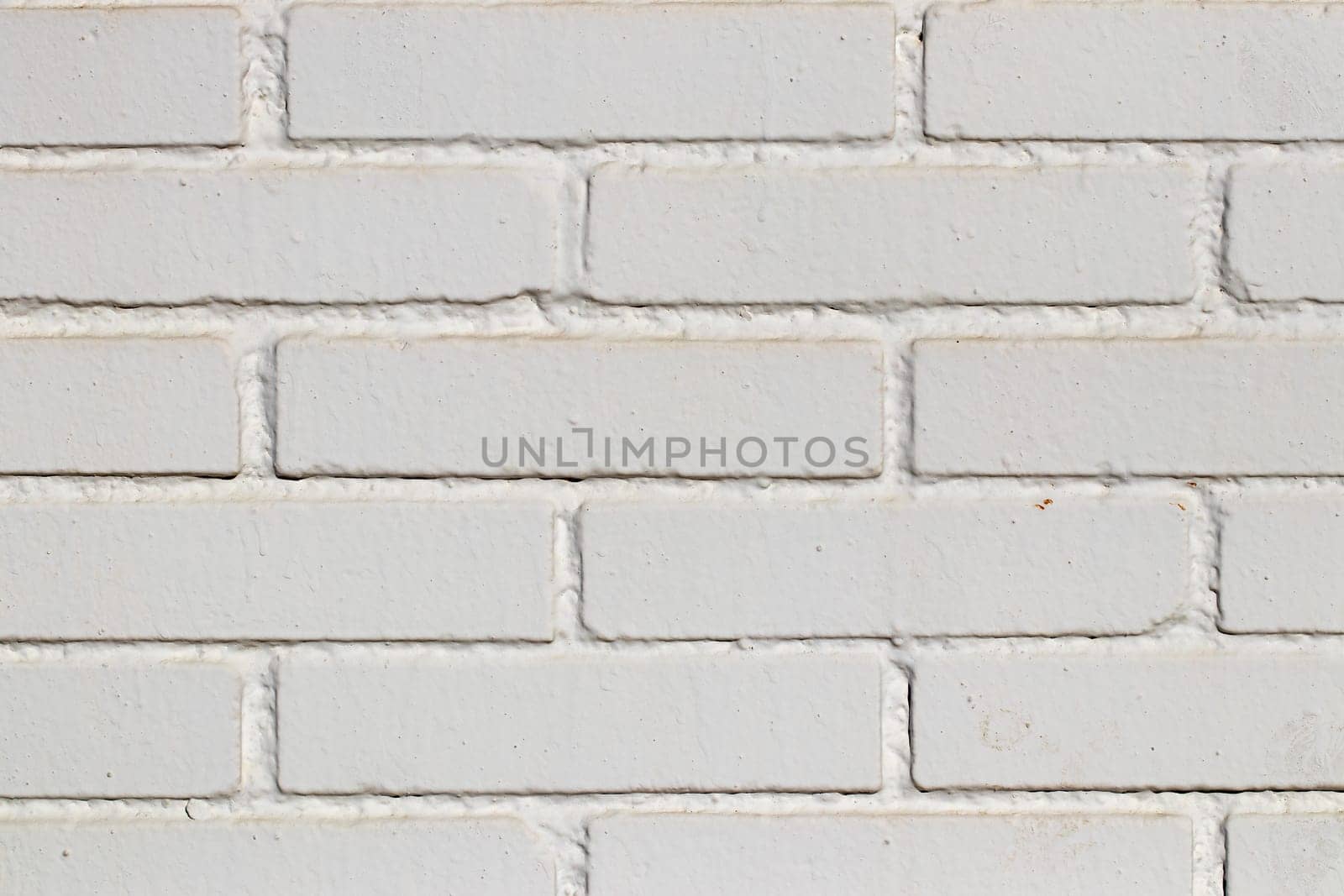 Stone texture background. Closeup of a old grunge white of a weathered brick wall texture. Abstract background concept, retro layout, interior design and wall banner. Macro photograph.