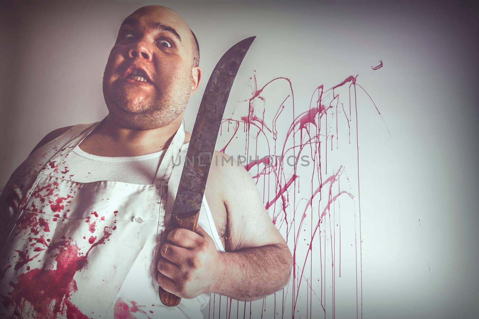 Crazy insane butcher covered with blood.  Harsh lighting from below for more disturbing feel.
