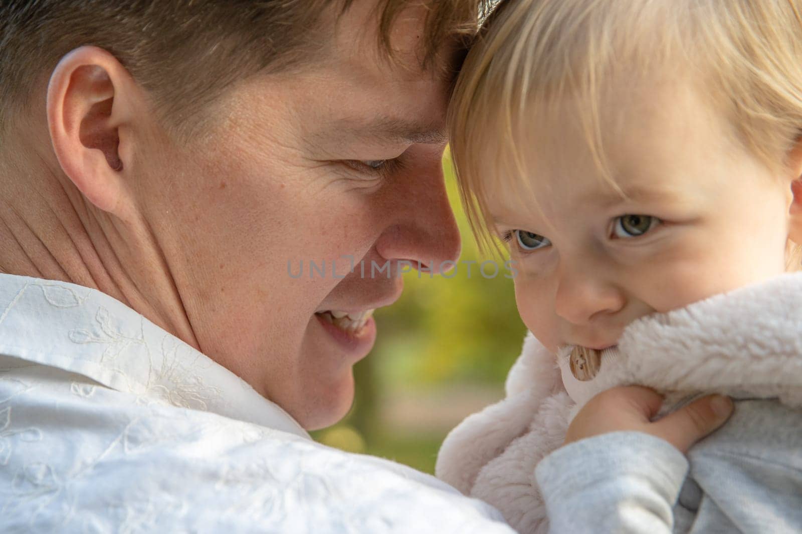 Dad and daughter enjoying autumn in a castle park at beautiful weather