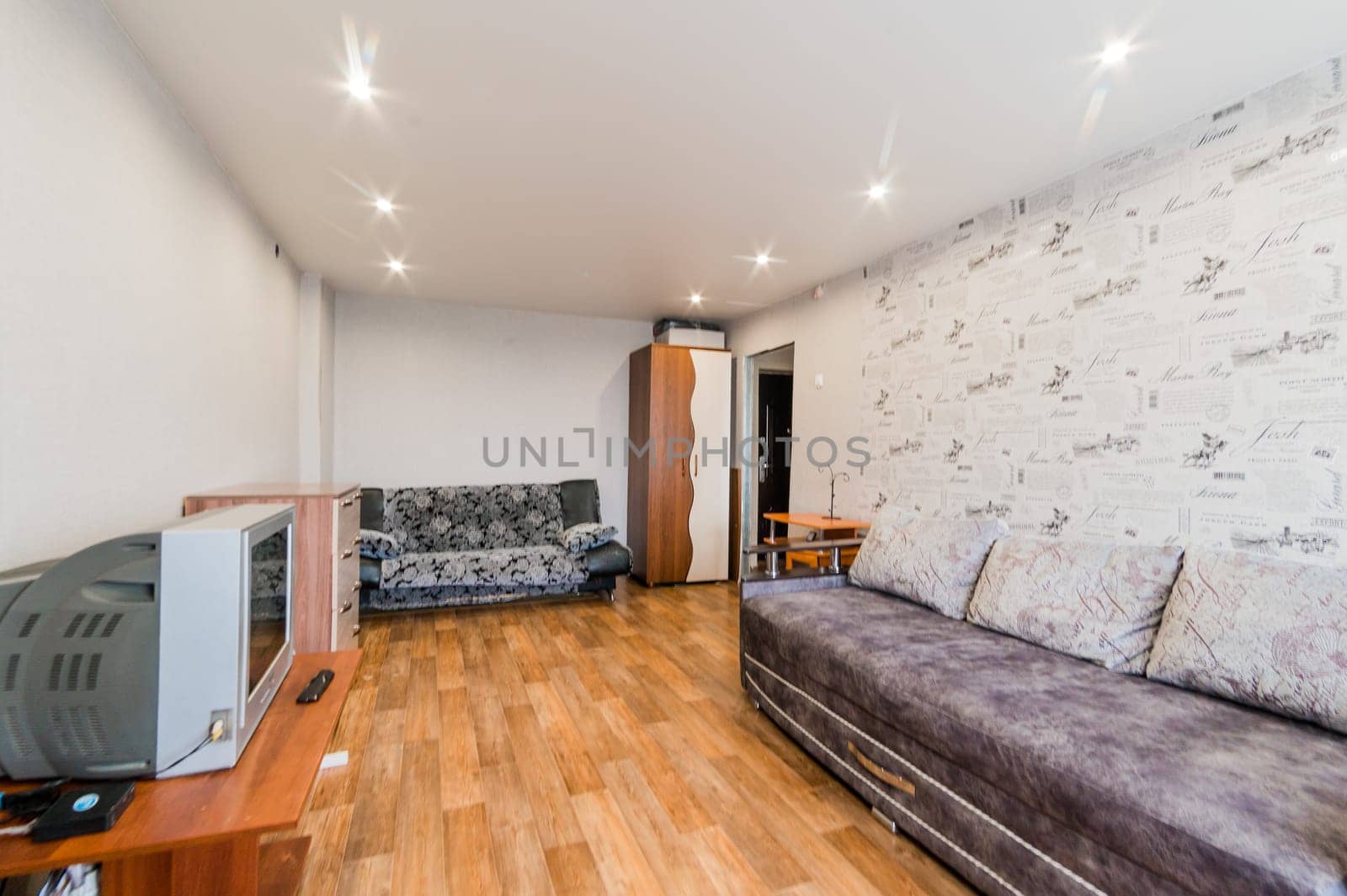 Russia, Moscow- July 23, 2019: interior room apartment. standard repair decoration in hostel. living room with sofa
