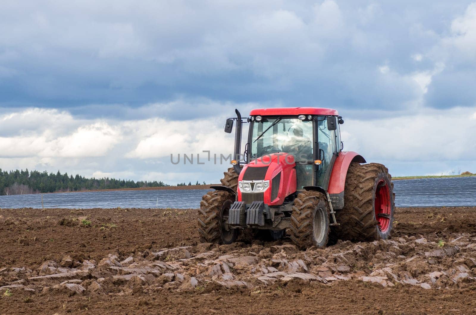 The tractor working on the large field