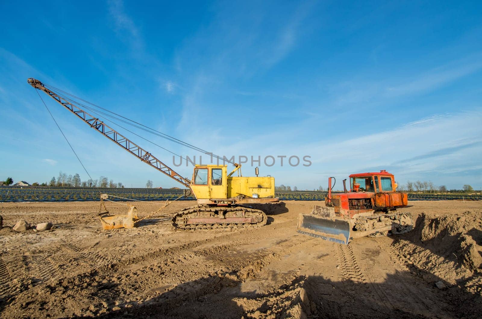Tractor and excavator stay in the after hard work