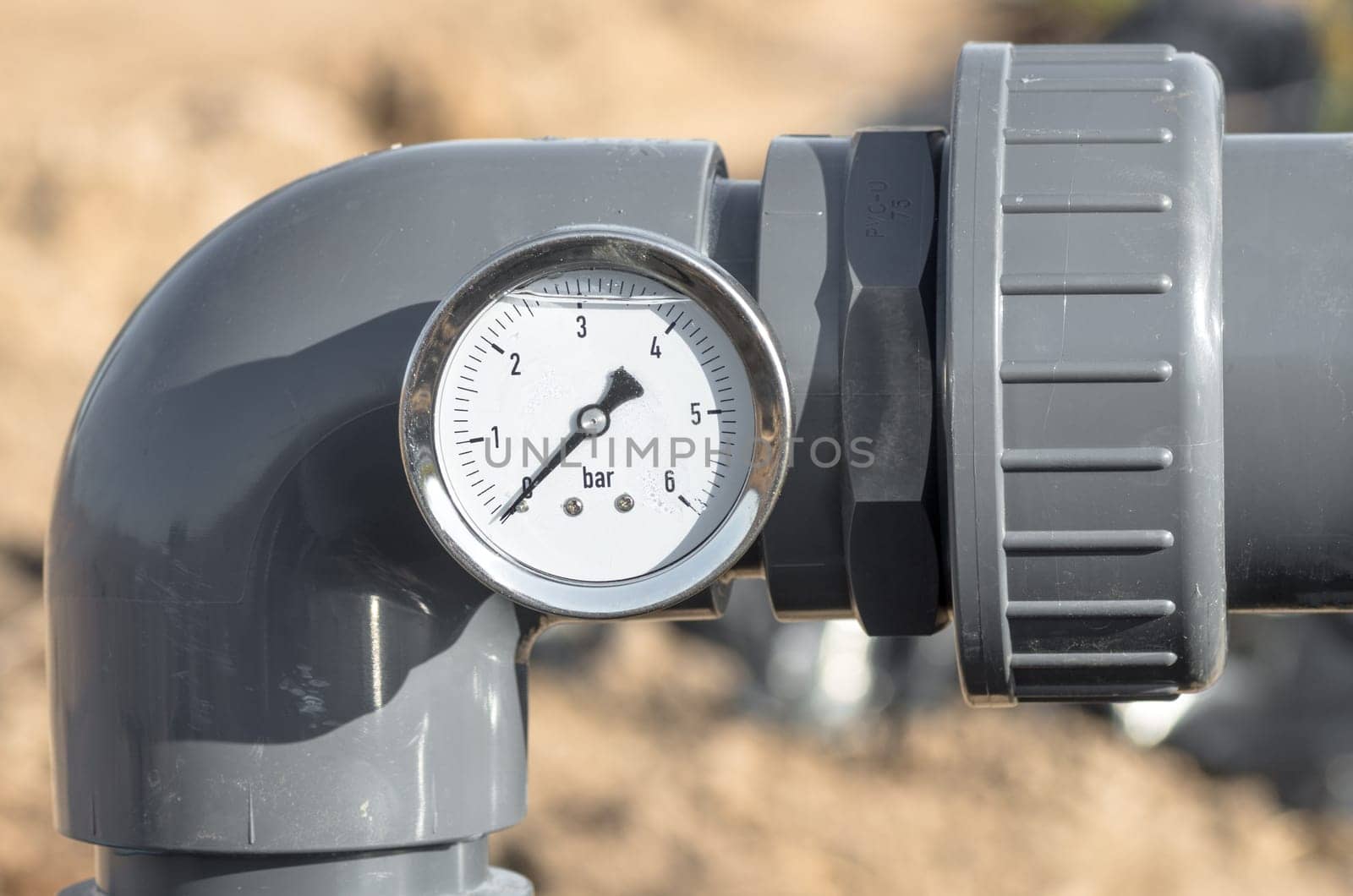 Close up of pressure gauge and pipes.