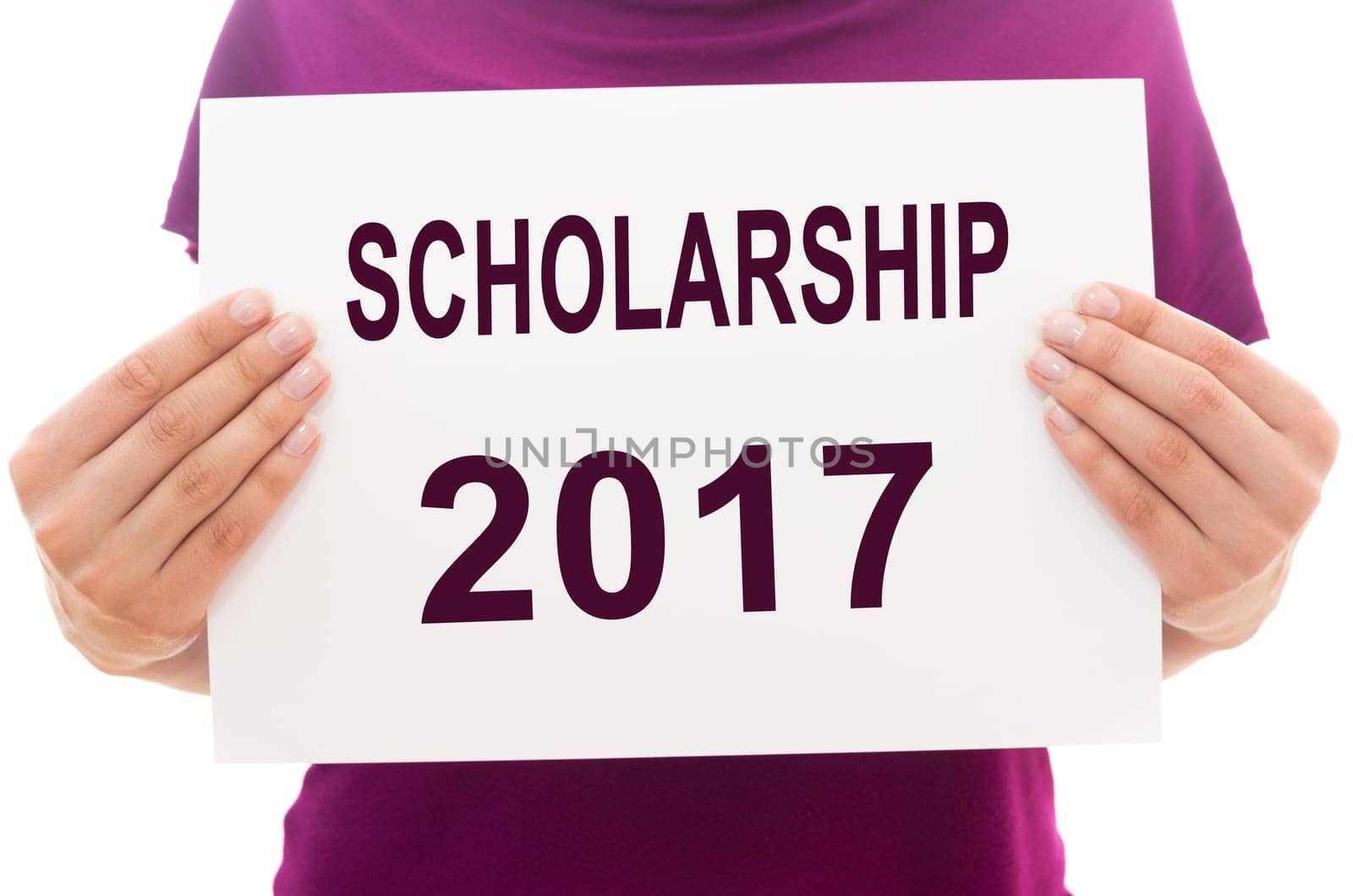 Girl holding white paper sheet with text SCHOLARSHIP 2017