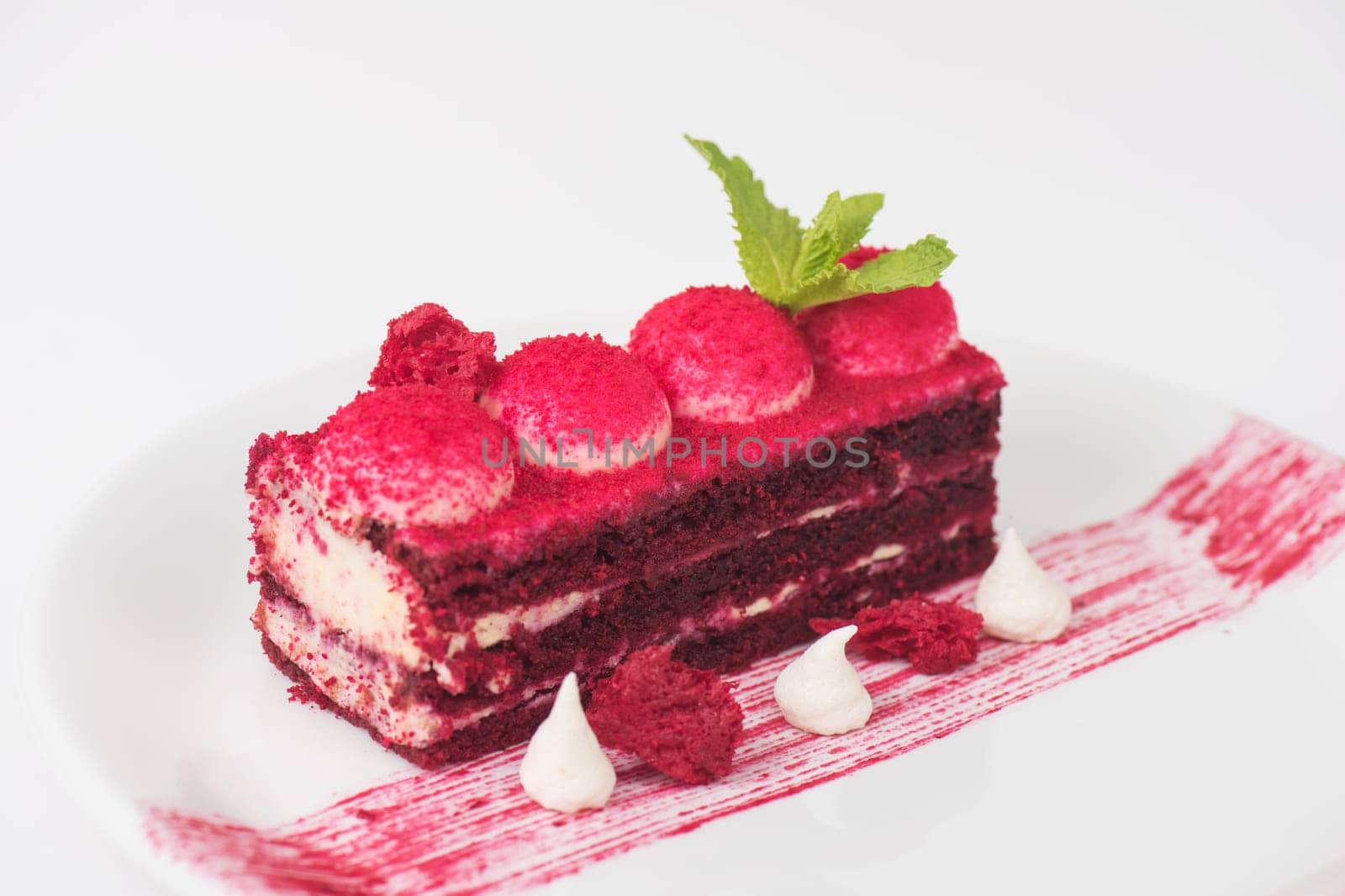 Plate with piece of delicious red velvet cake on white background