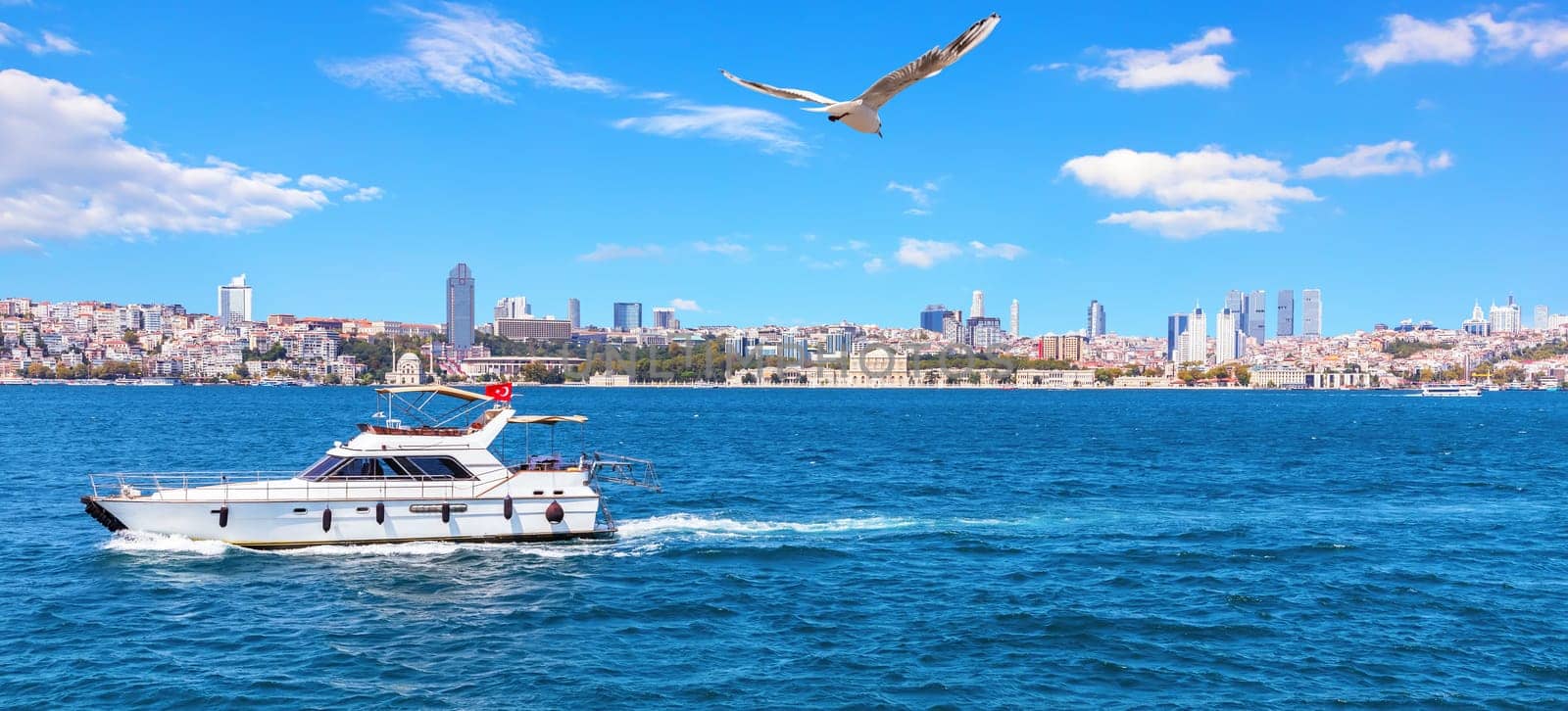 Yacht in the Bosporus and Besiktas view, Istanbul.