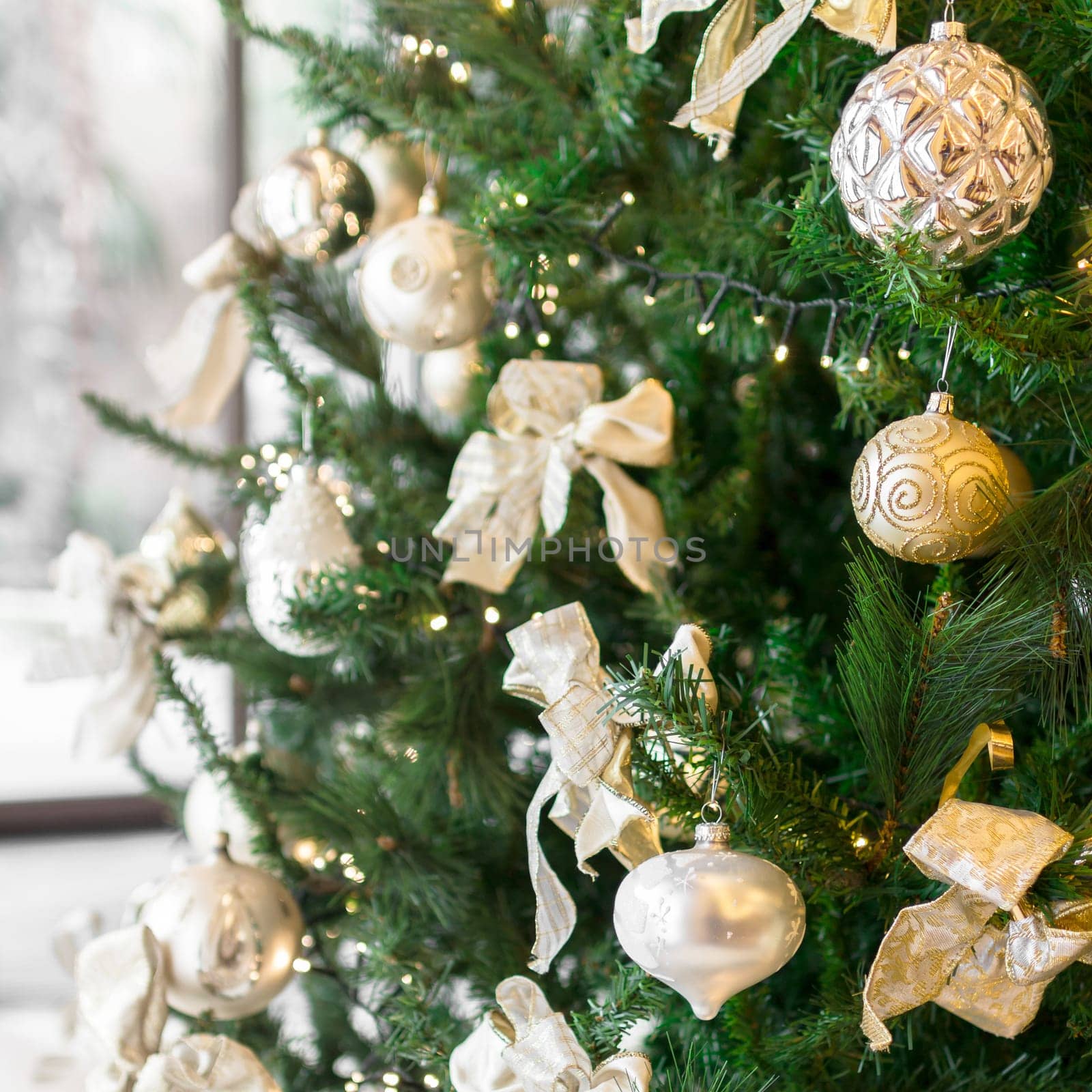 Christmas tree with ornaments. Defocused blurry background. Close-up.