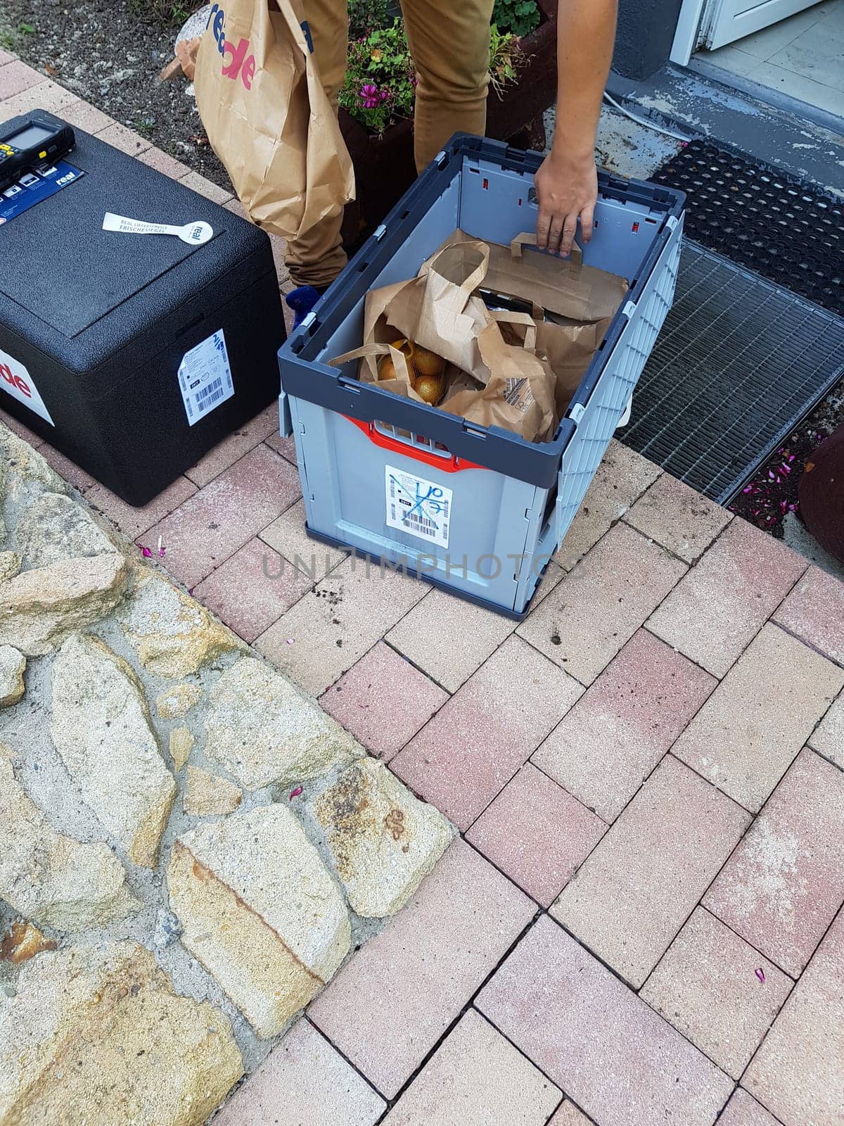 HEILIGENHAUS, NRW, GERMANY - JULY 25, 2017:.Homeservice, delivery of department store chain Real in Germany delivers crate of fresh food and frozen food home.