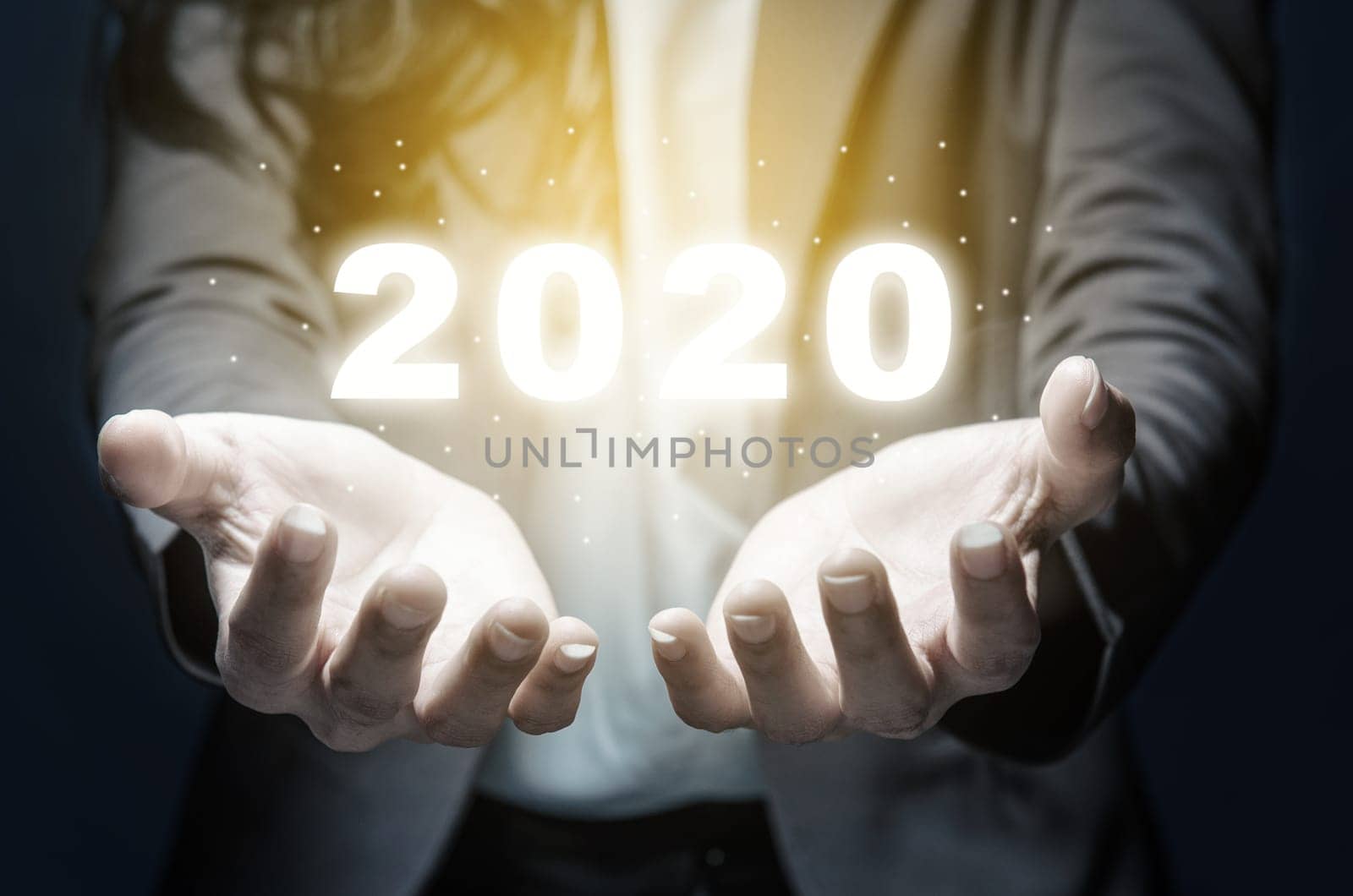 Businesswoman showing a digital number of 2020 on her hands. Happy New Year 2020